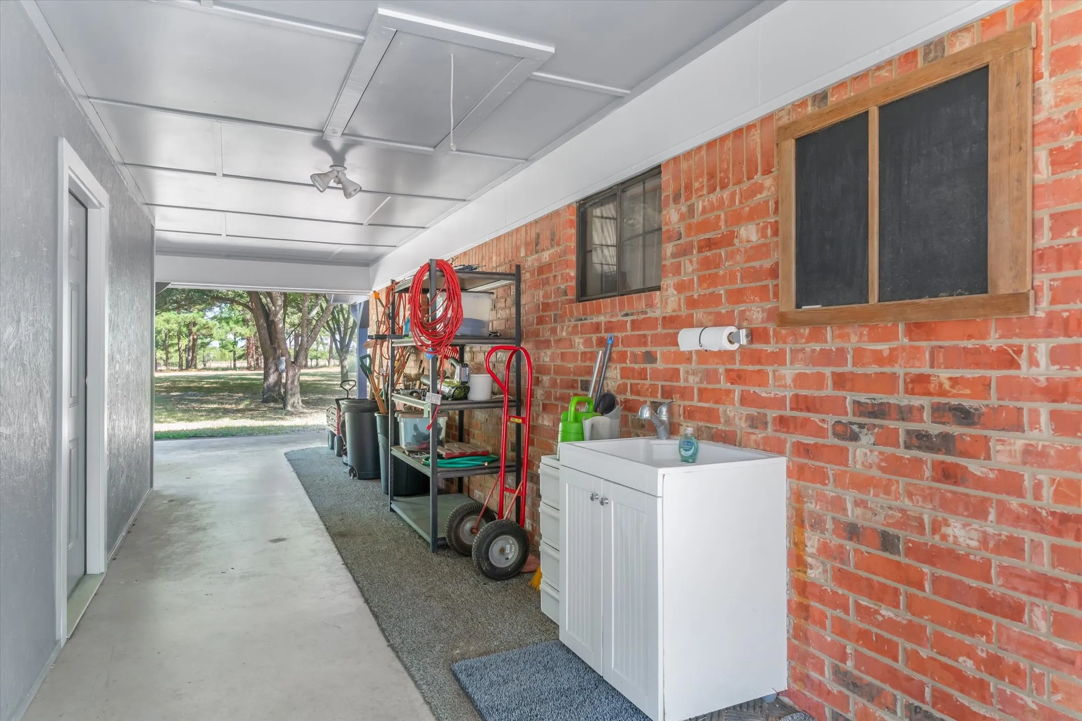 Breezeway between the home and finished out 20x20 storage entry.  Outside sink for easy cleanup