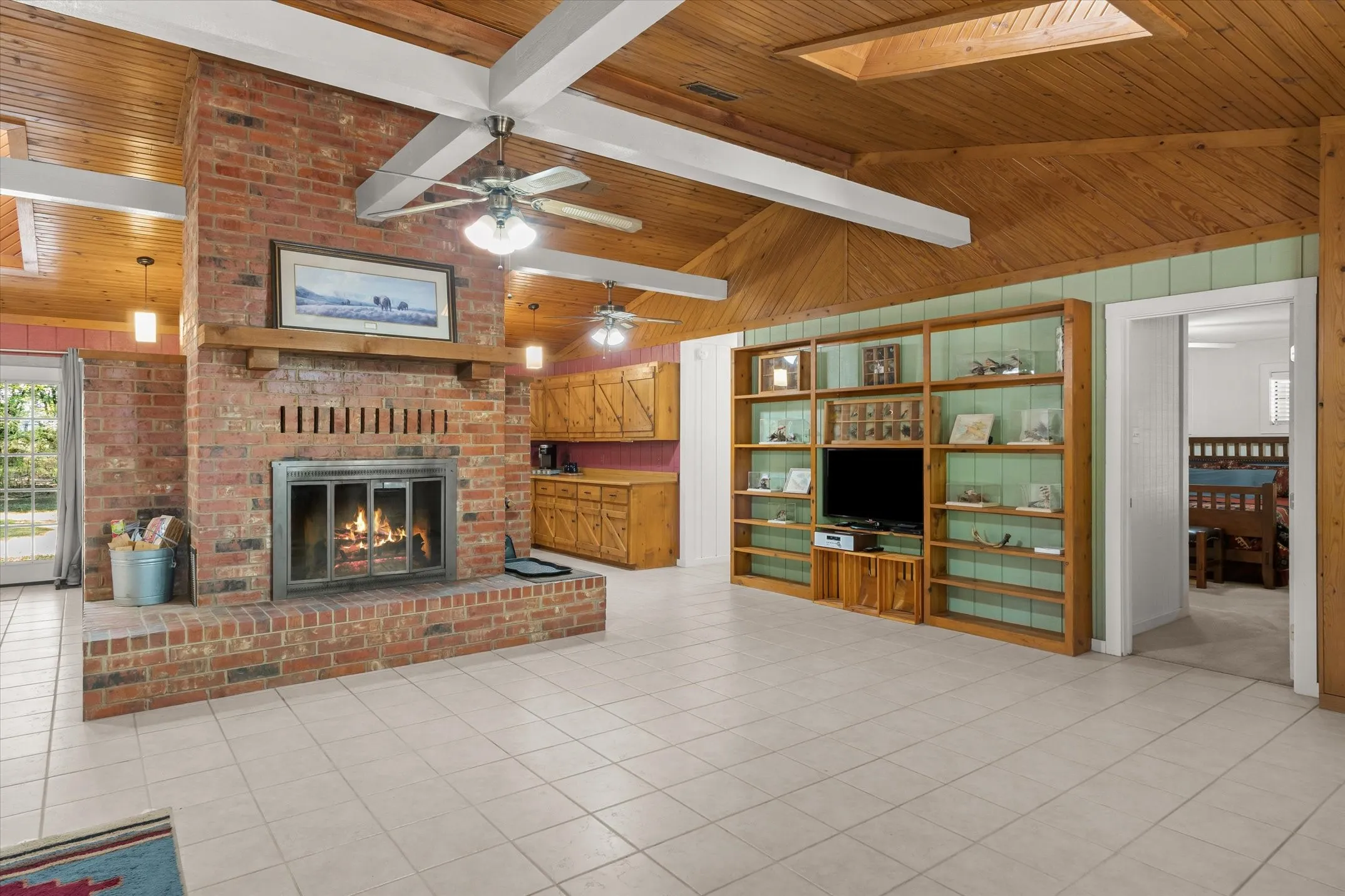 Shelving in front of shiplap walls, and skylights were added in 2016. Master bedroom is the only bedoom on the west end of the home