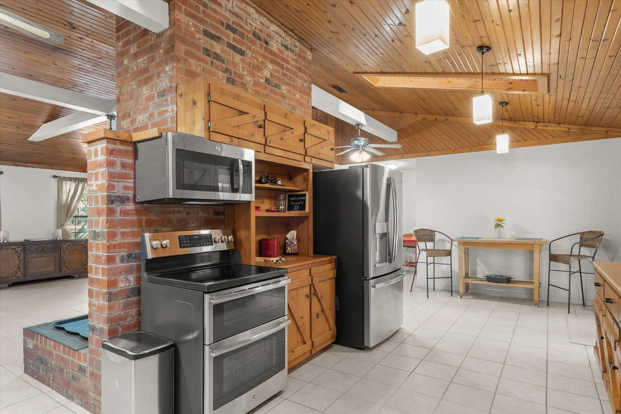 This brick wall in the kitchen makes the pine cabinets look amazing