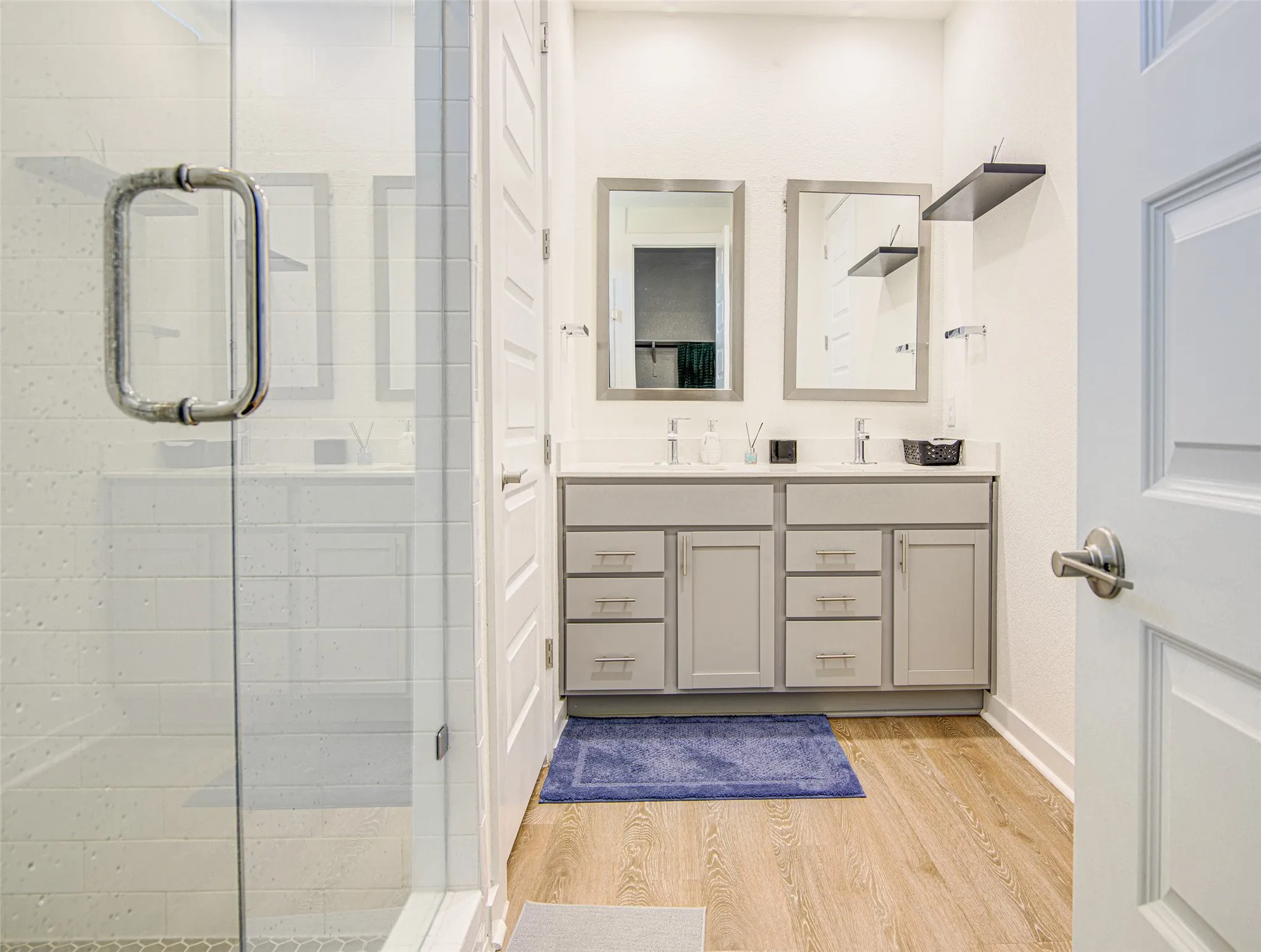 Dual vanity with light gray cabinetry and brushed nickel hardware