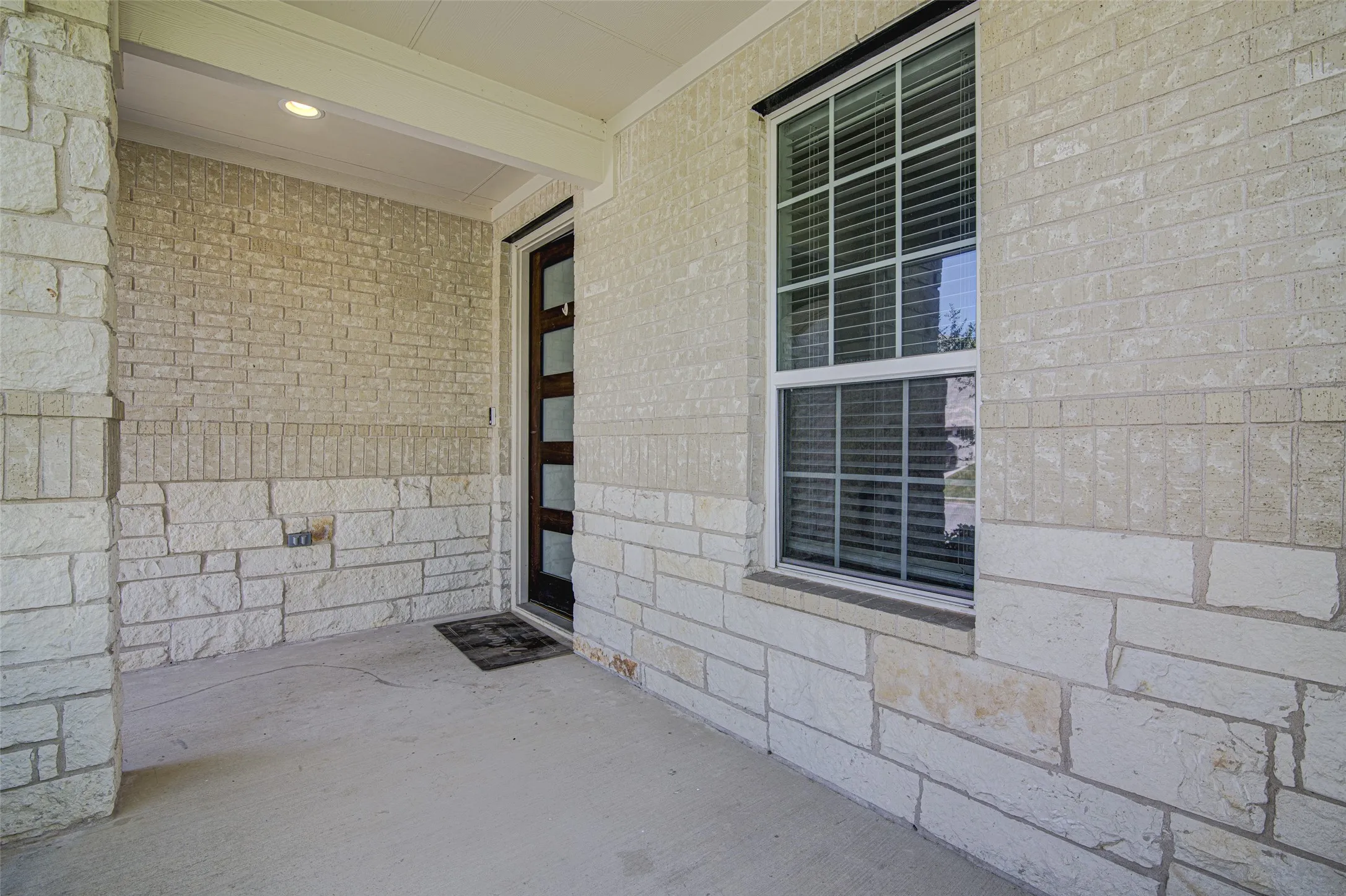 Stone and brick exterior with a covered porch