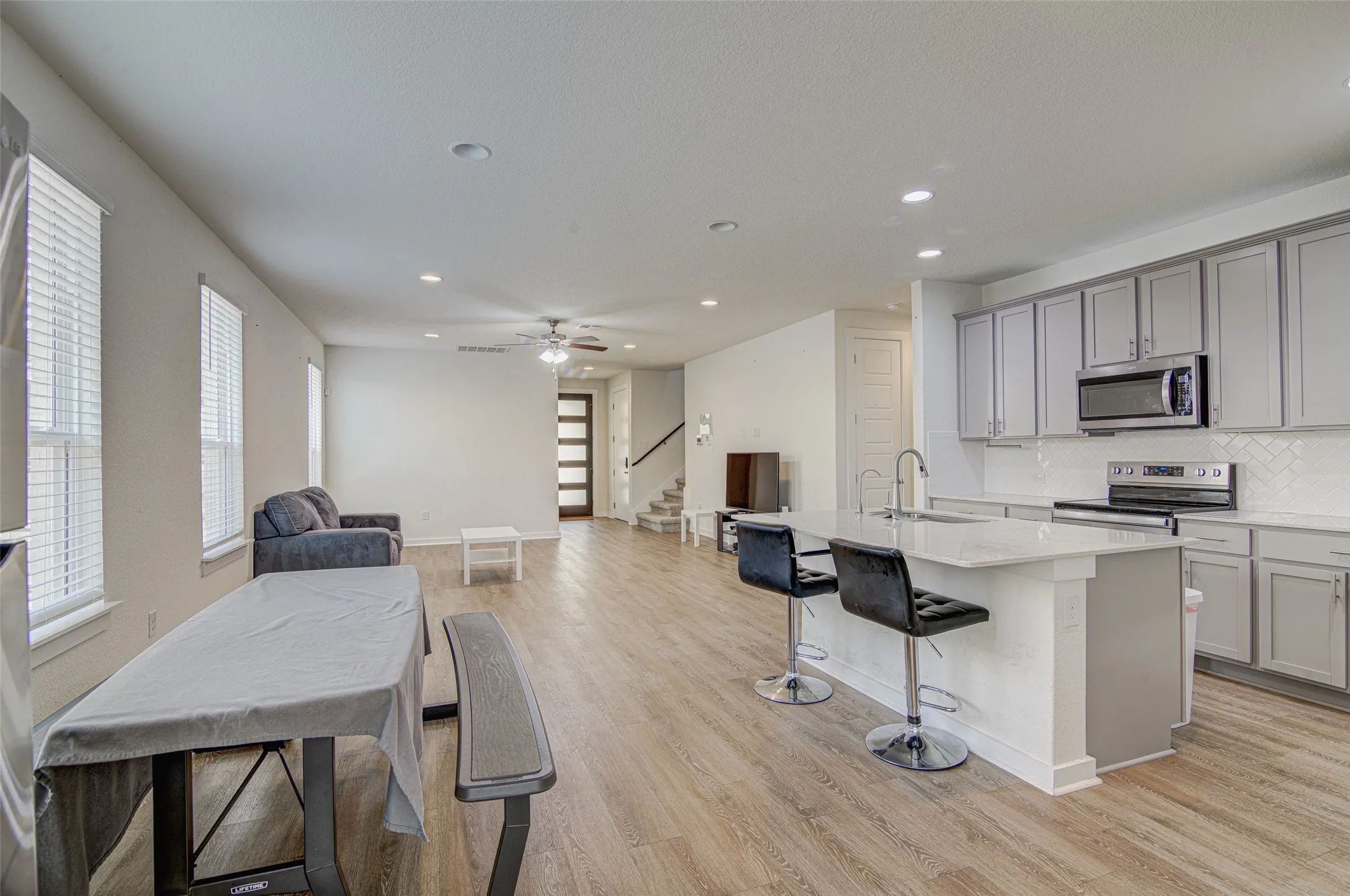 Open-concept living space with wood-finish flooring
