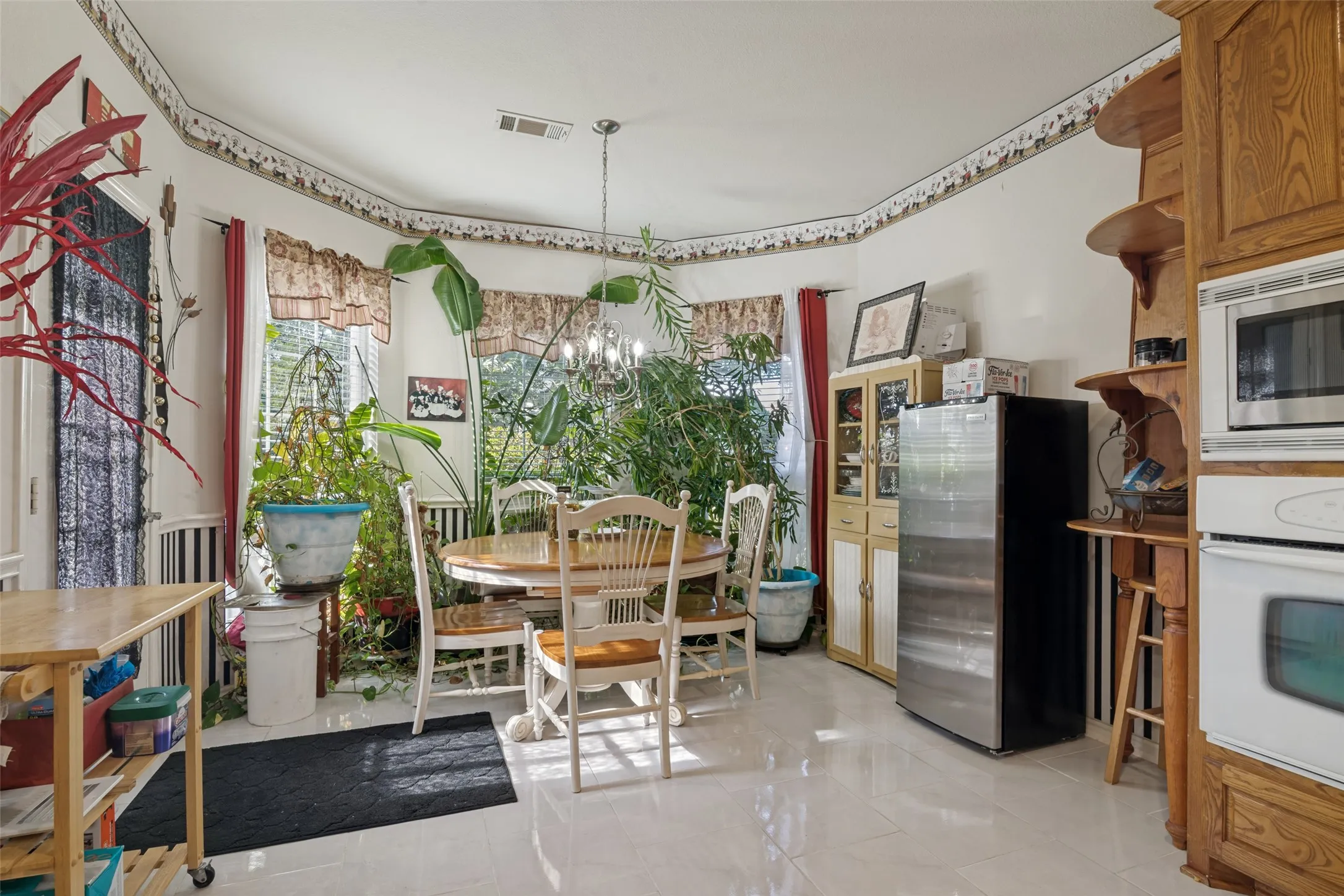 Recessed lighting, bay window, chandelier lighting, built-in cabinetry, wall-mounted oven