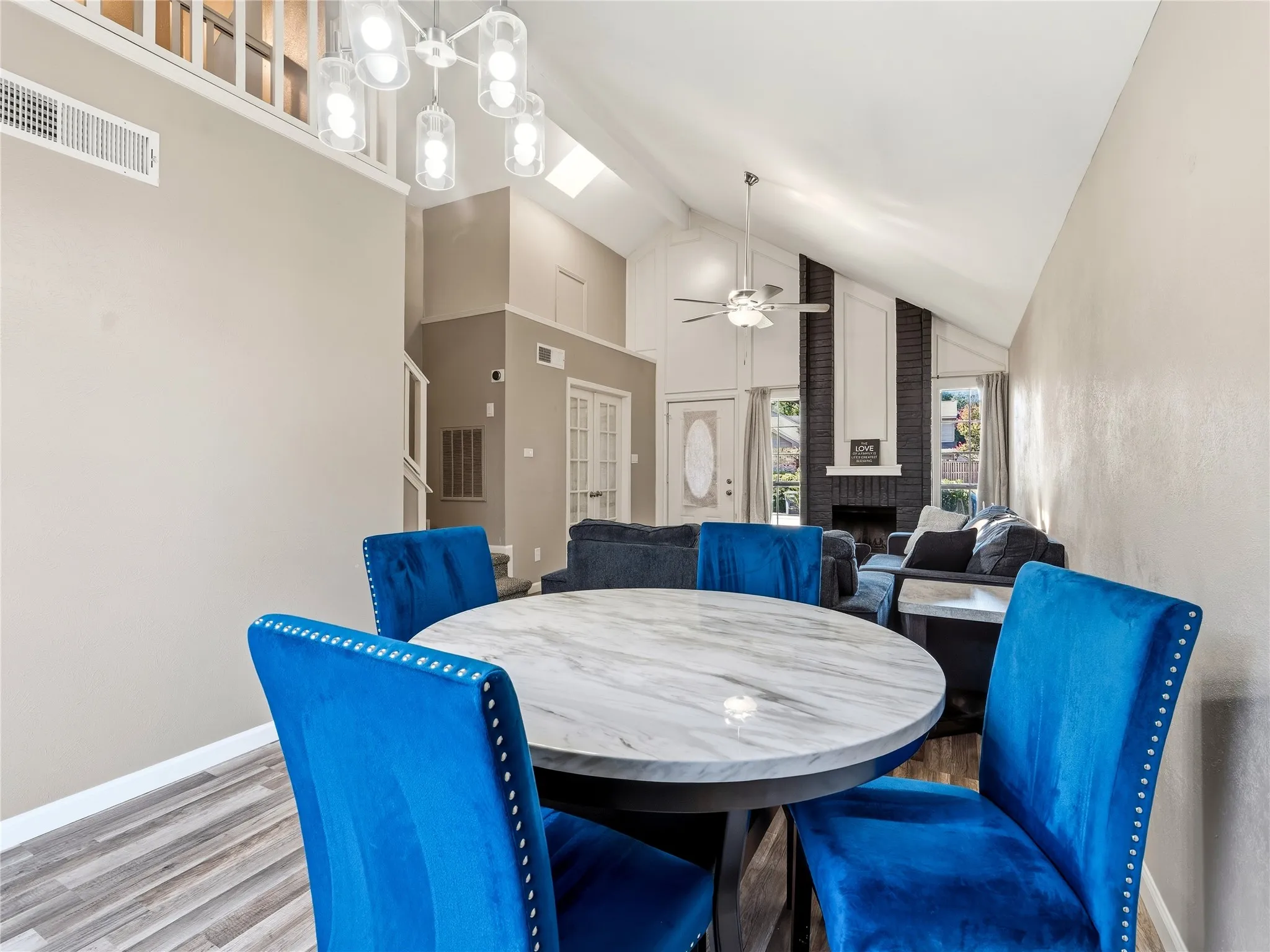 Vaulted ceilings with a ceiling fan, recessed lighting, and a skylight
