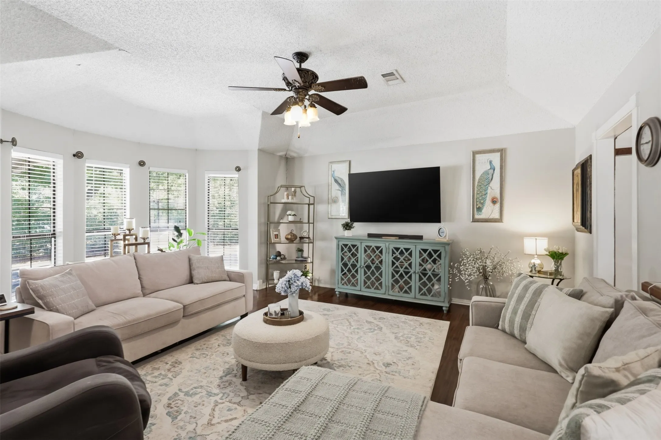 Vaulted ceiling with a ceiling fan, recessed lighting, and wood-finish flooring