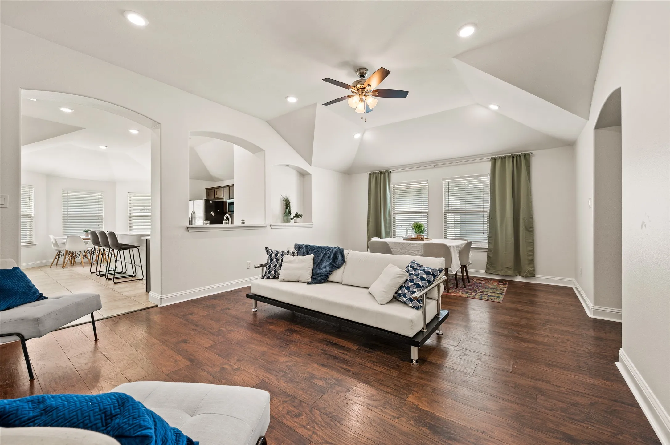 Wood-finish flooring throughout, recessed lighting, and vaulted ceilings