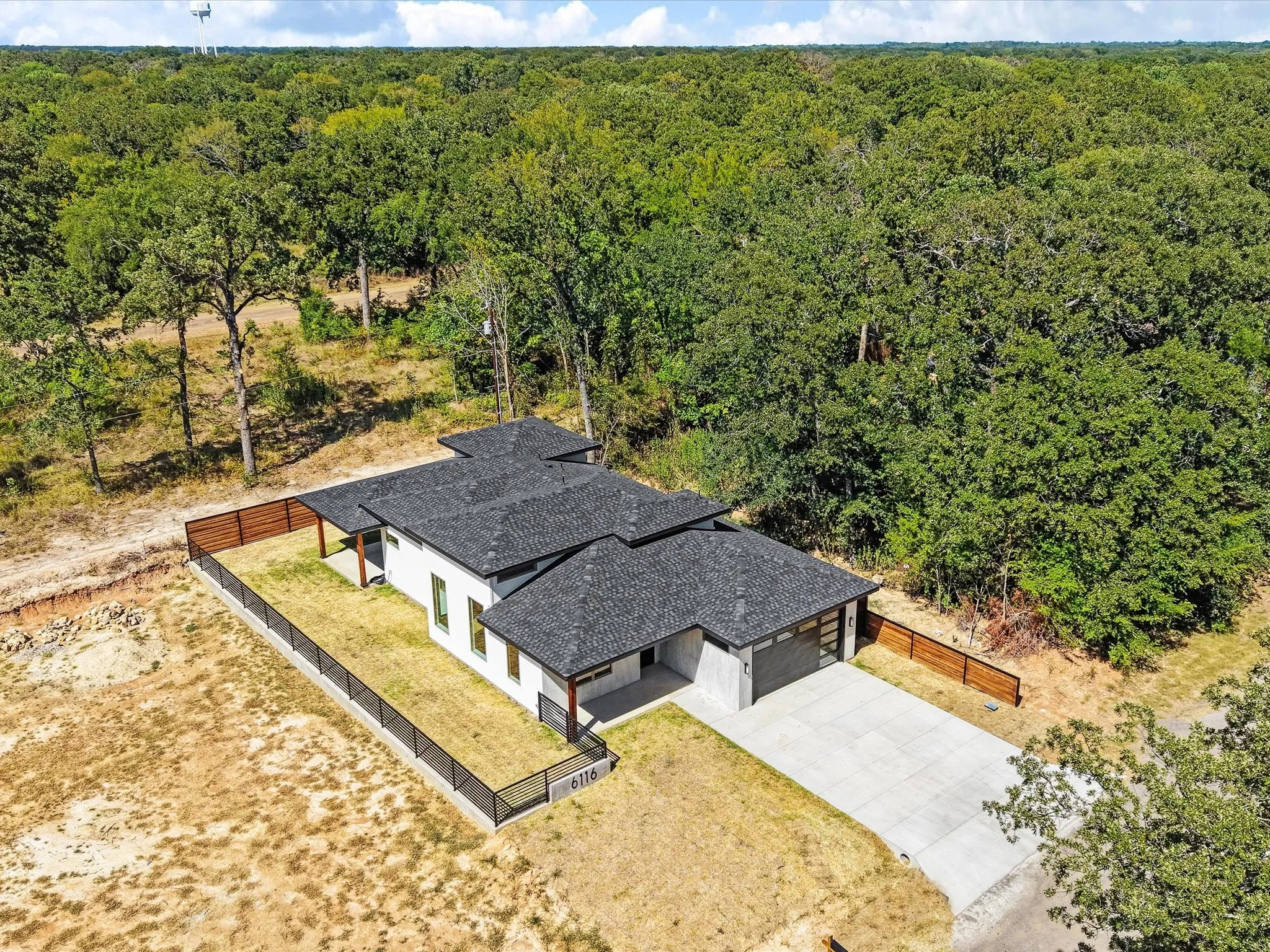 Contemporary exterior with a dark shingle roof and white siding