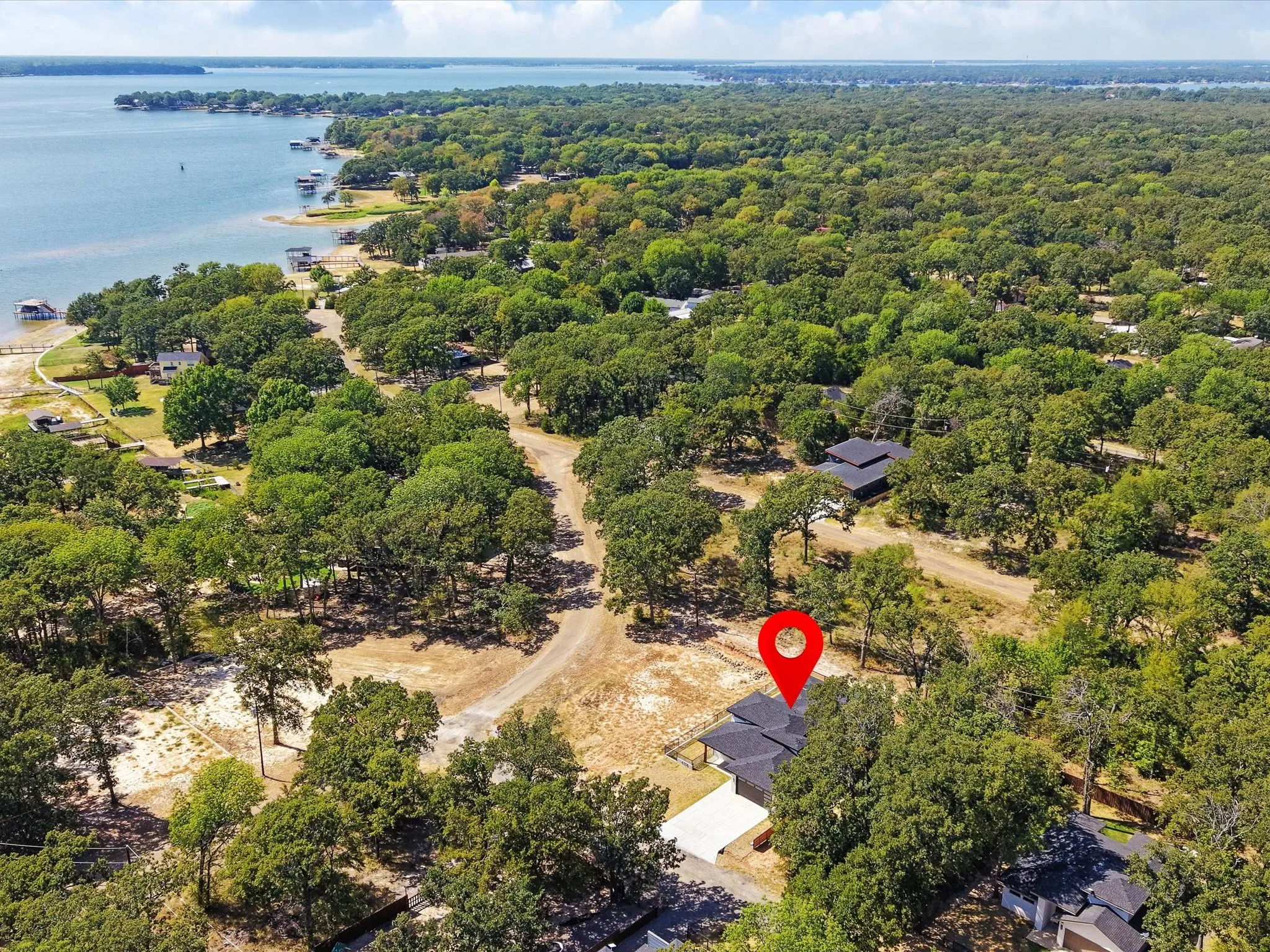 Waterfront property with mature trees, natural landscaping, and a direct water presence