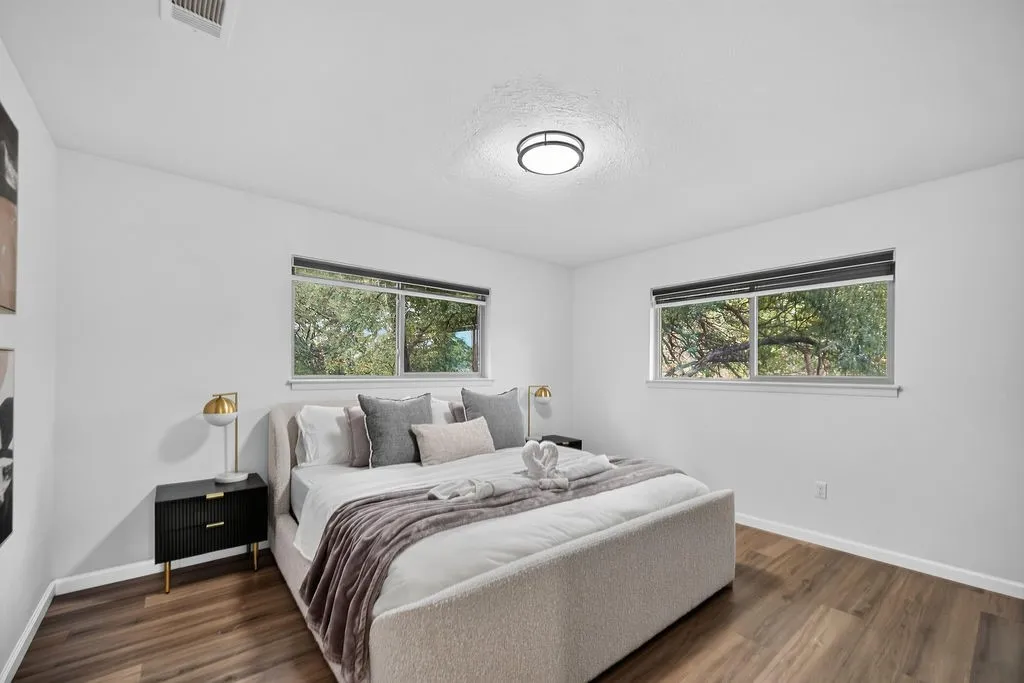 Wood-finish flooring, recessed lighting, and dual windows