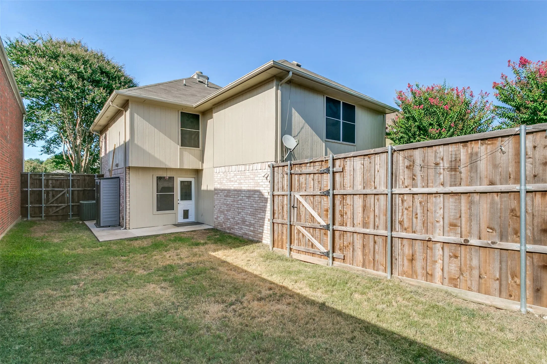 Low maintenance backyard with exterior siding and fencing upgraded