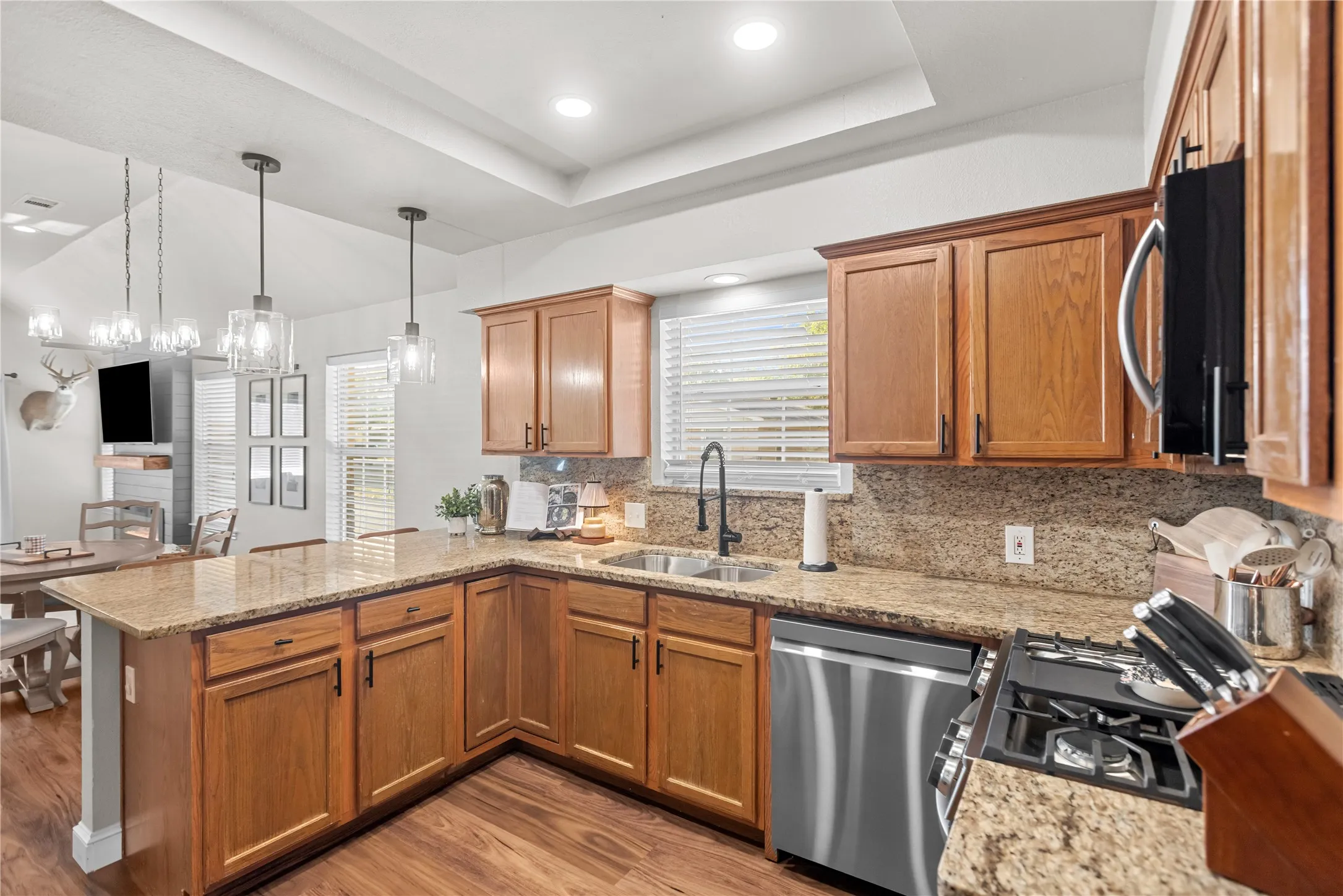 The open kitchen creates an inviting gathering space for family and friends.