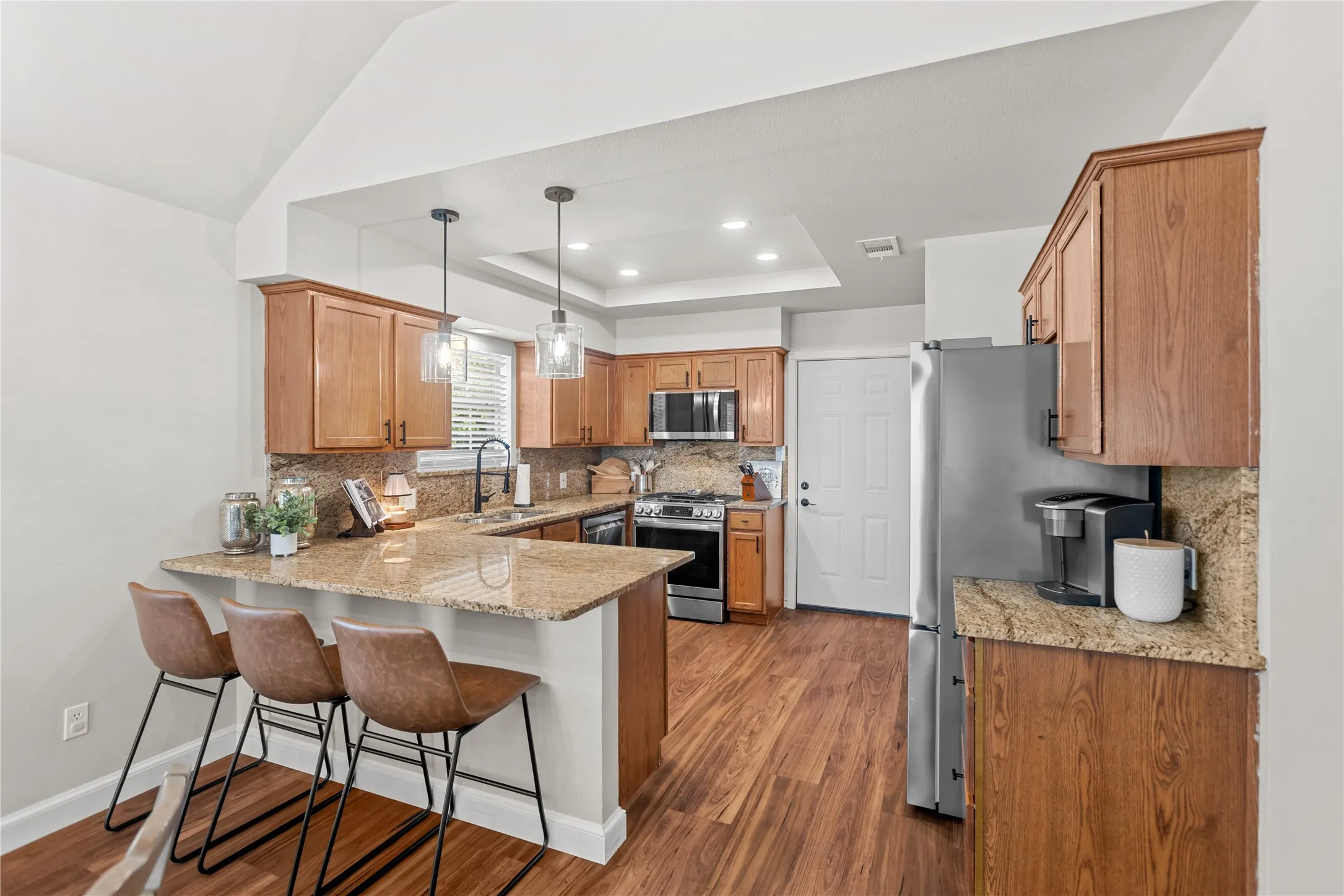 Large peninsula creates additional counter space and a natural connection to the living area.