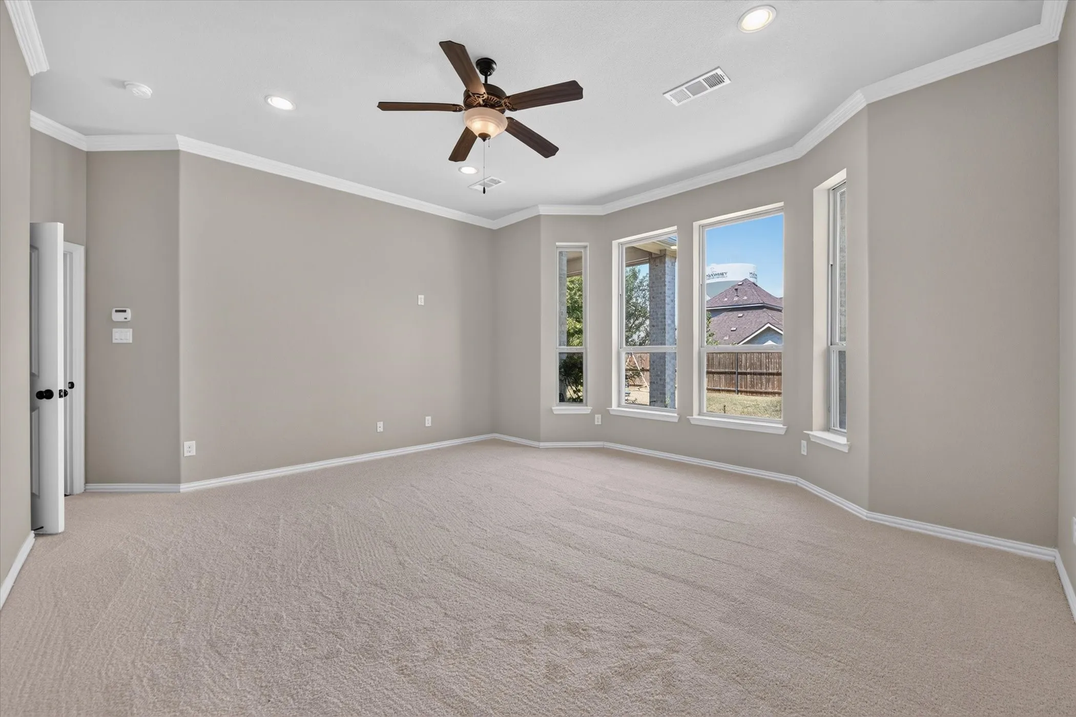 Expansive room featuring carpet flooring, recessed lighting, and a ceiling fan