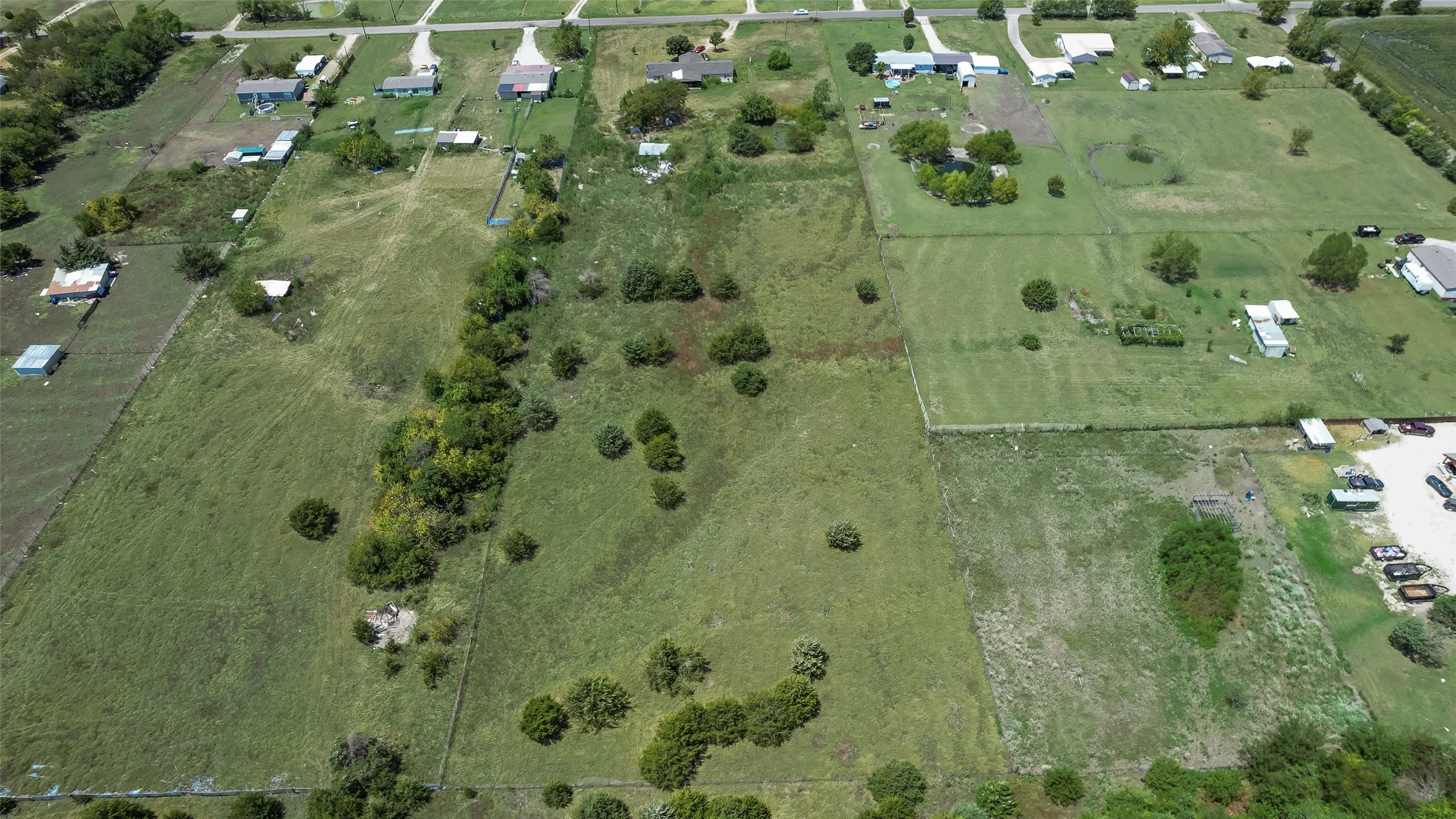 Expansive undeveloped land featuring natural foliage and scattered trees