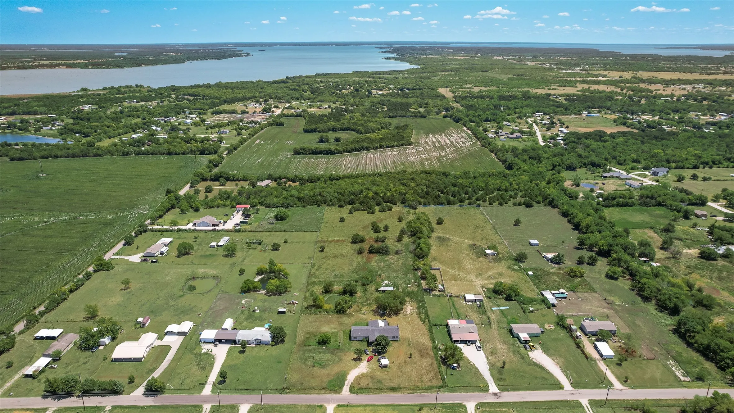 Expansive acreage featuring mature trees and a substantial body of water
