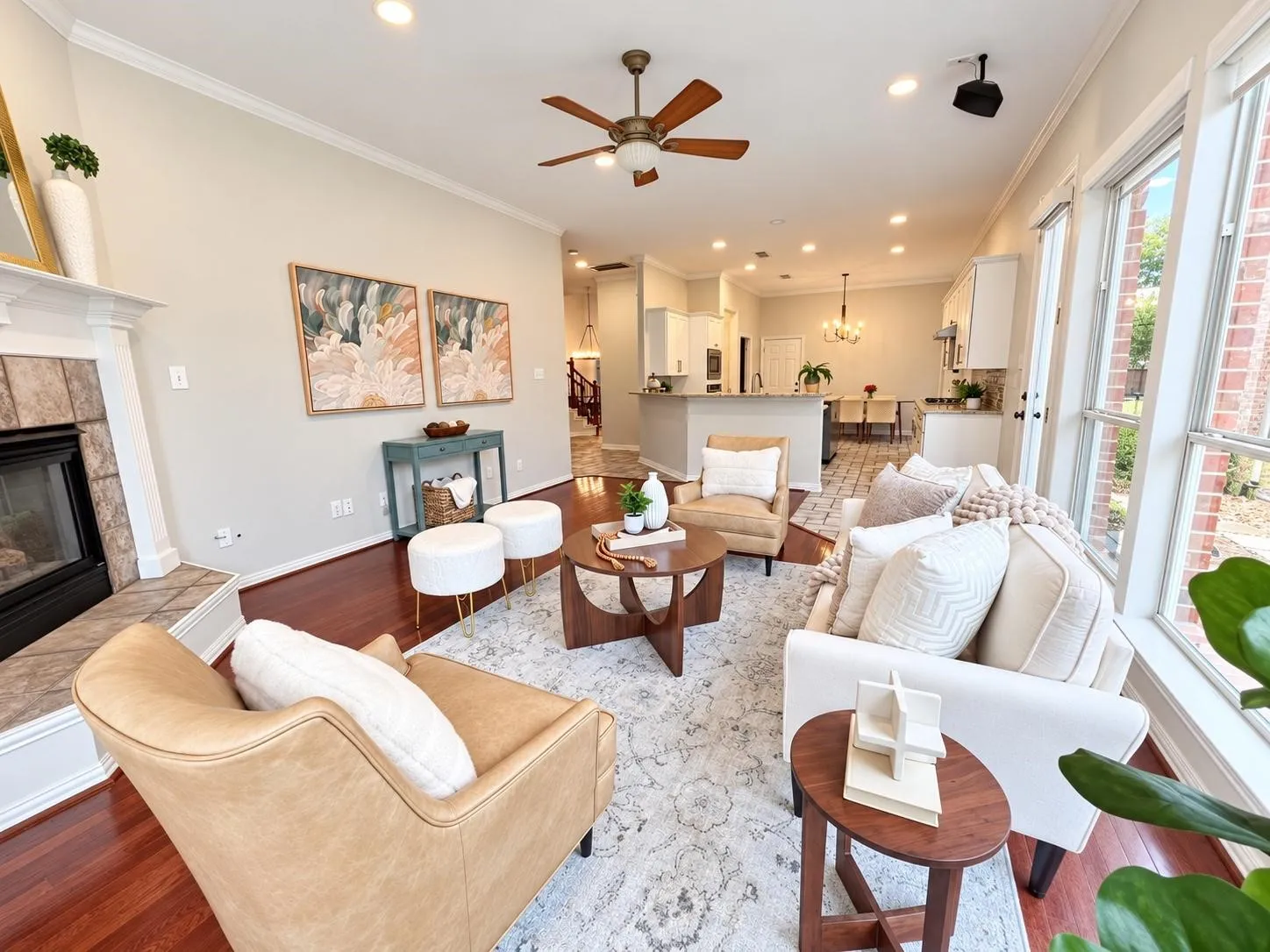 Open-concept living space featuring wood-finish flooring, a ceiling fan, recessed lighting, and large windows