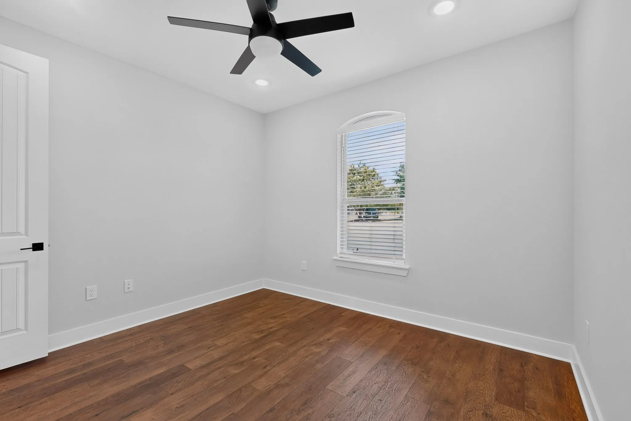 Wood-finish flooring, recessed lighting, and a modern ceiling fan