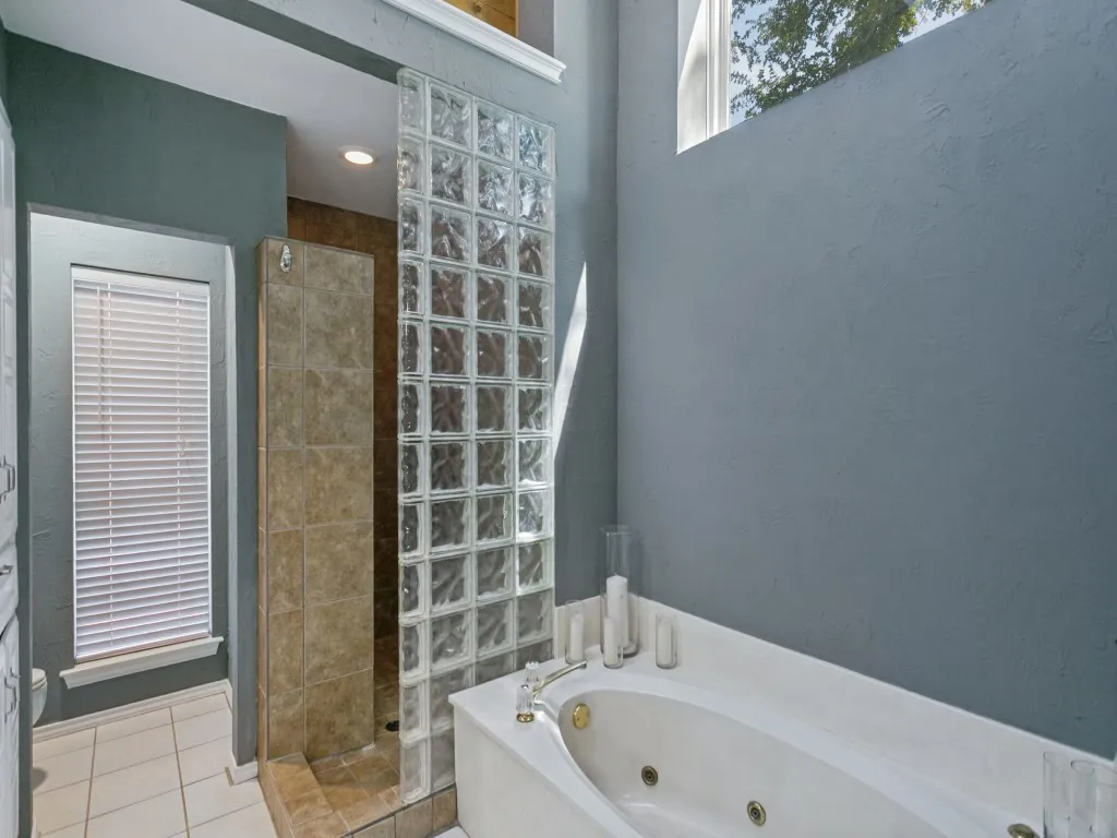 A large walk-in shower for a quick morning or jetted soaking tub for a quiet evening.