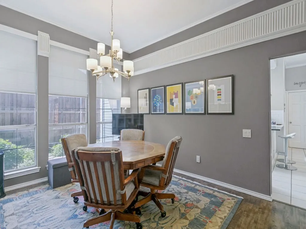 Formal dining area with multiple windows, a decorative chandelier, and crown molding