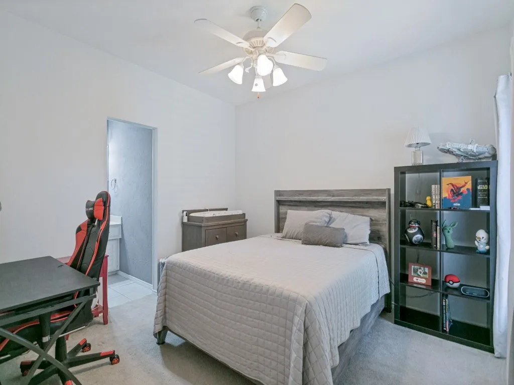 Secondary bedroom with ceiling fan, walk-in closet and jack and jill ensuite bath.