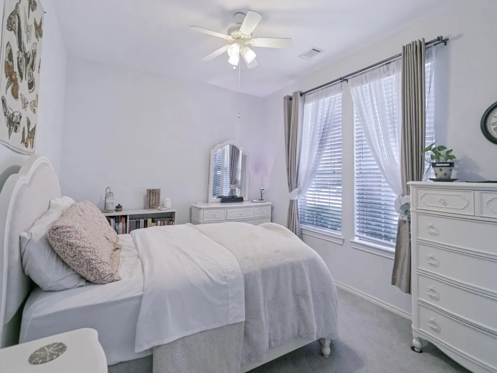 Secondary bedroom with ceiling fan, walk-in closet and jack and jill ensuite bath.