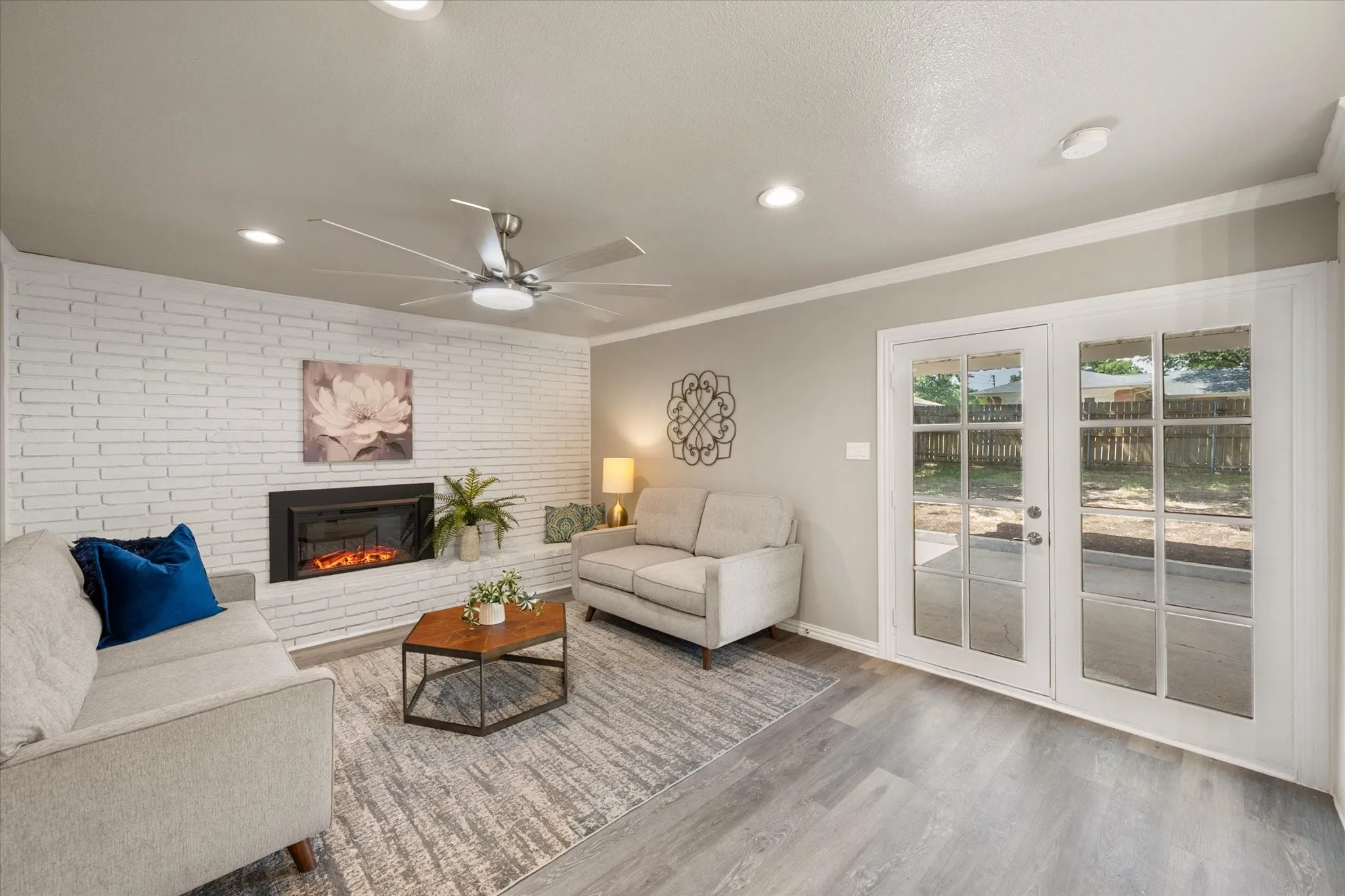 Enjoy the cozy electric fireplace that can provide ambiance in the warmer months and actual heat in the cold months. This family room could also be used as a large dining area. French doors lead out to the covered patio