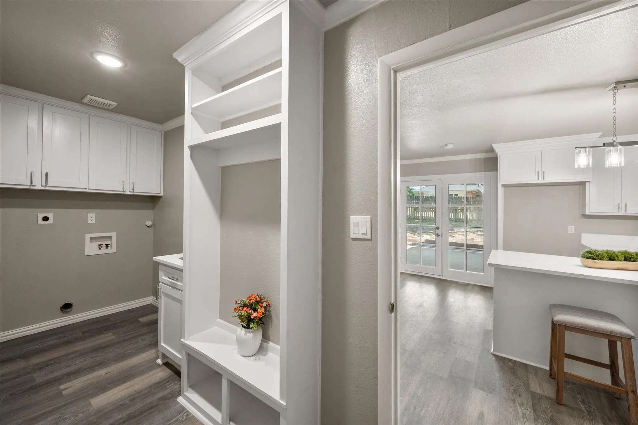 Extra storage, a utility sink and mud bench make this a very convenient use of space