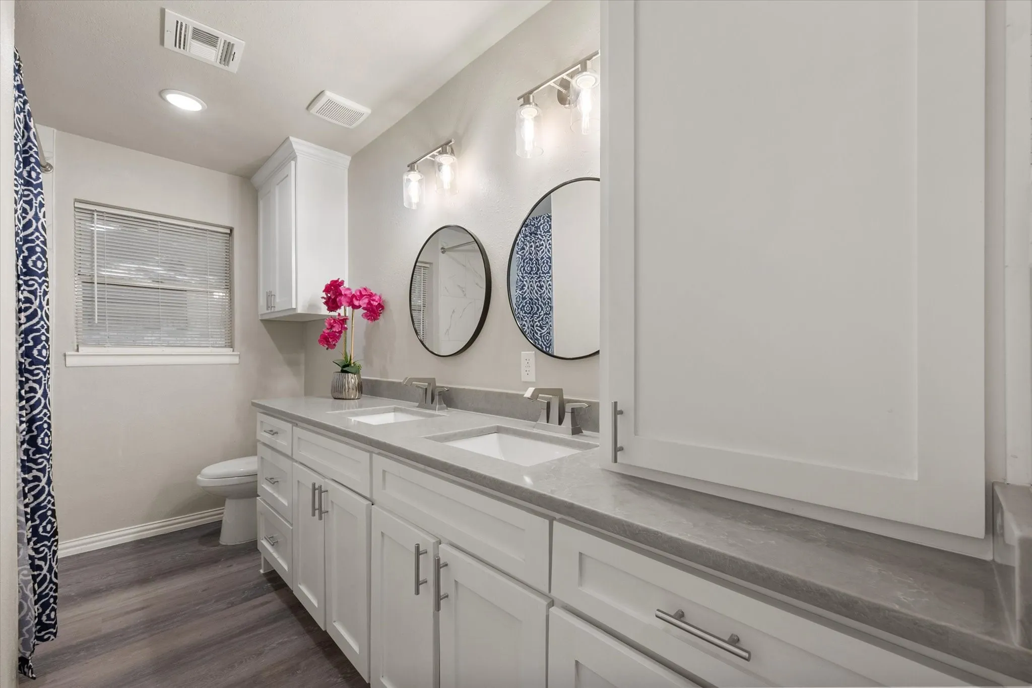 Hall bath has dual sinks, new cabinets,new countertops, new lighting and lots of storage