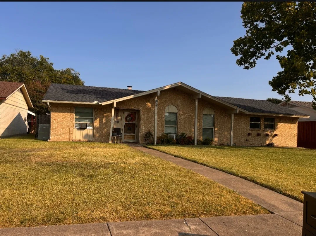 Single-story property featuring a brick exterior and a dark shingle roof