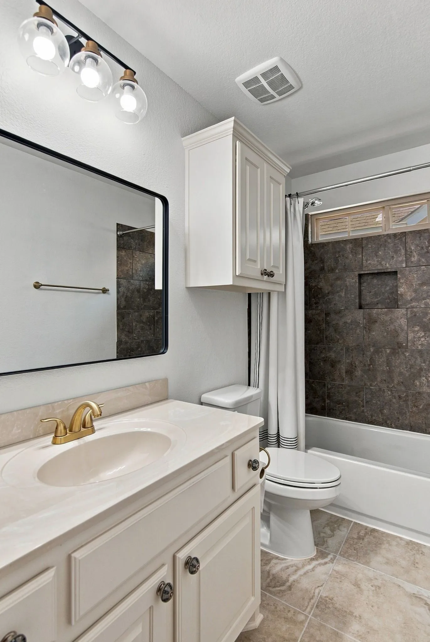 Vanity with integrated sink, brass-finish faucet, and coordinating hardware