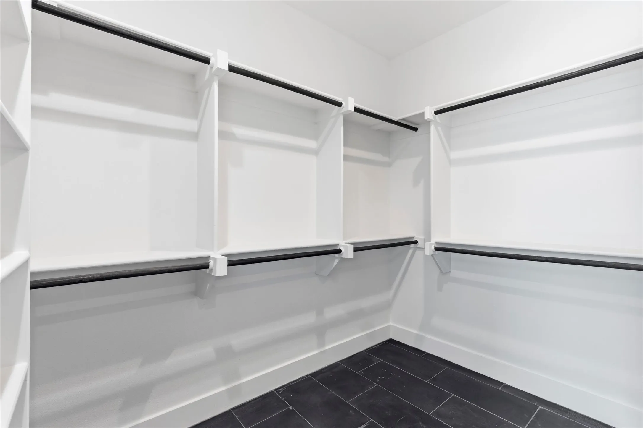 Expansive closet with tiled flooring