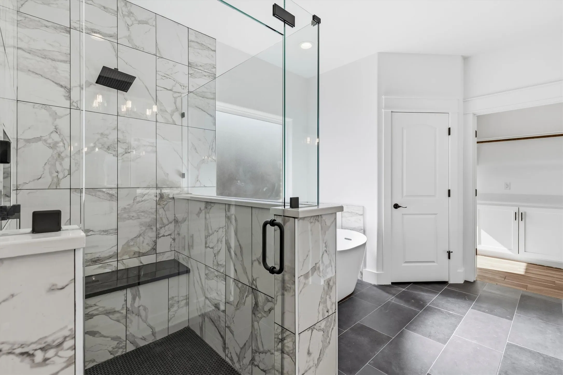 Porcelain tiles in oversized walk in shower with bench