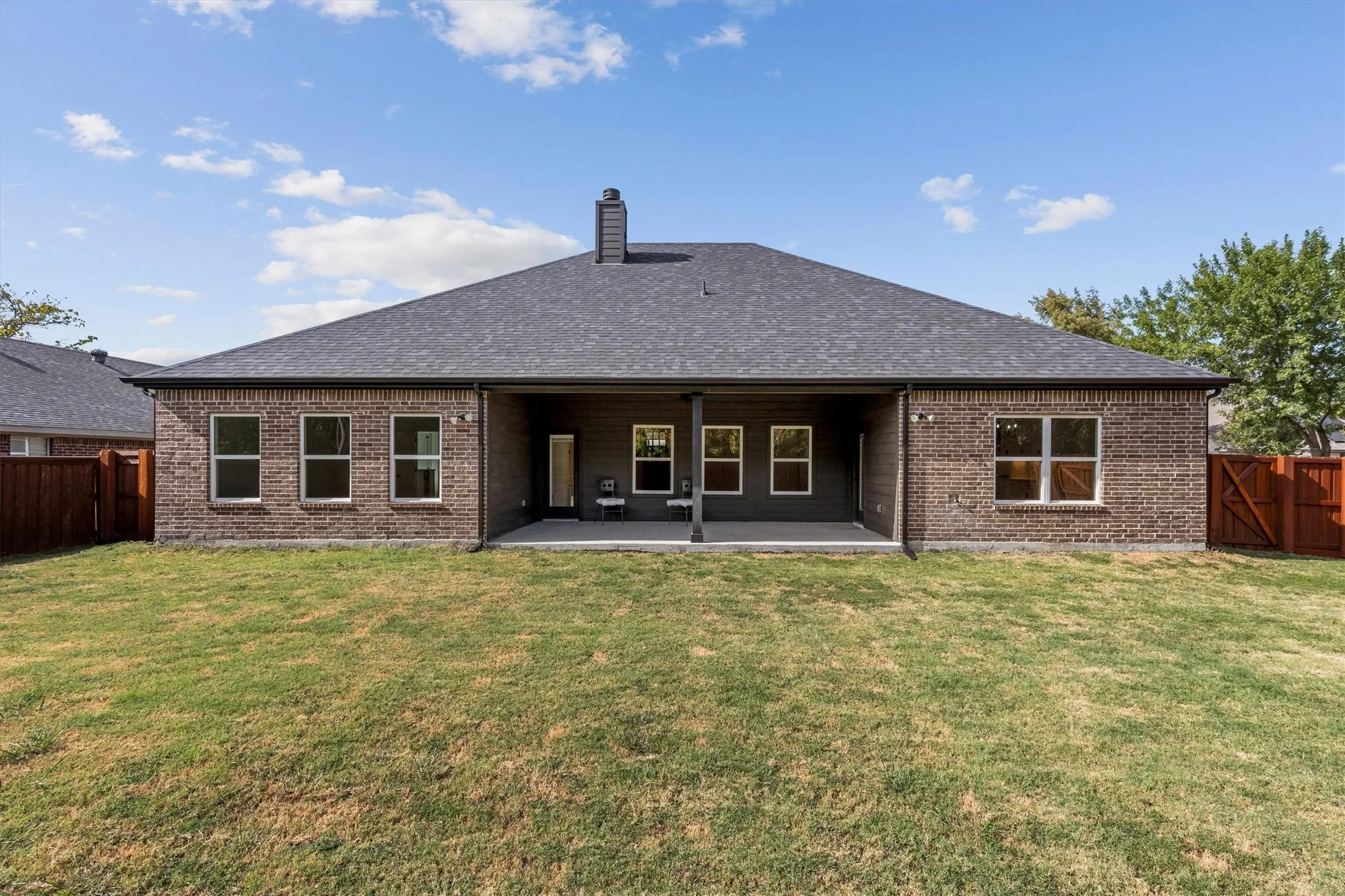 Back of house with large covered patio