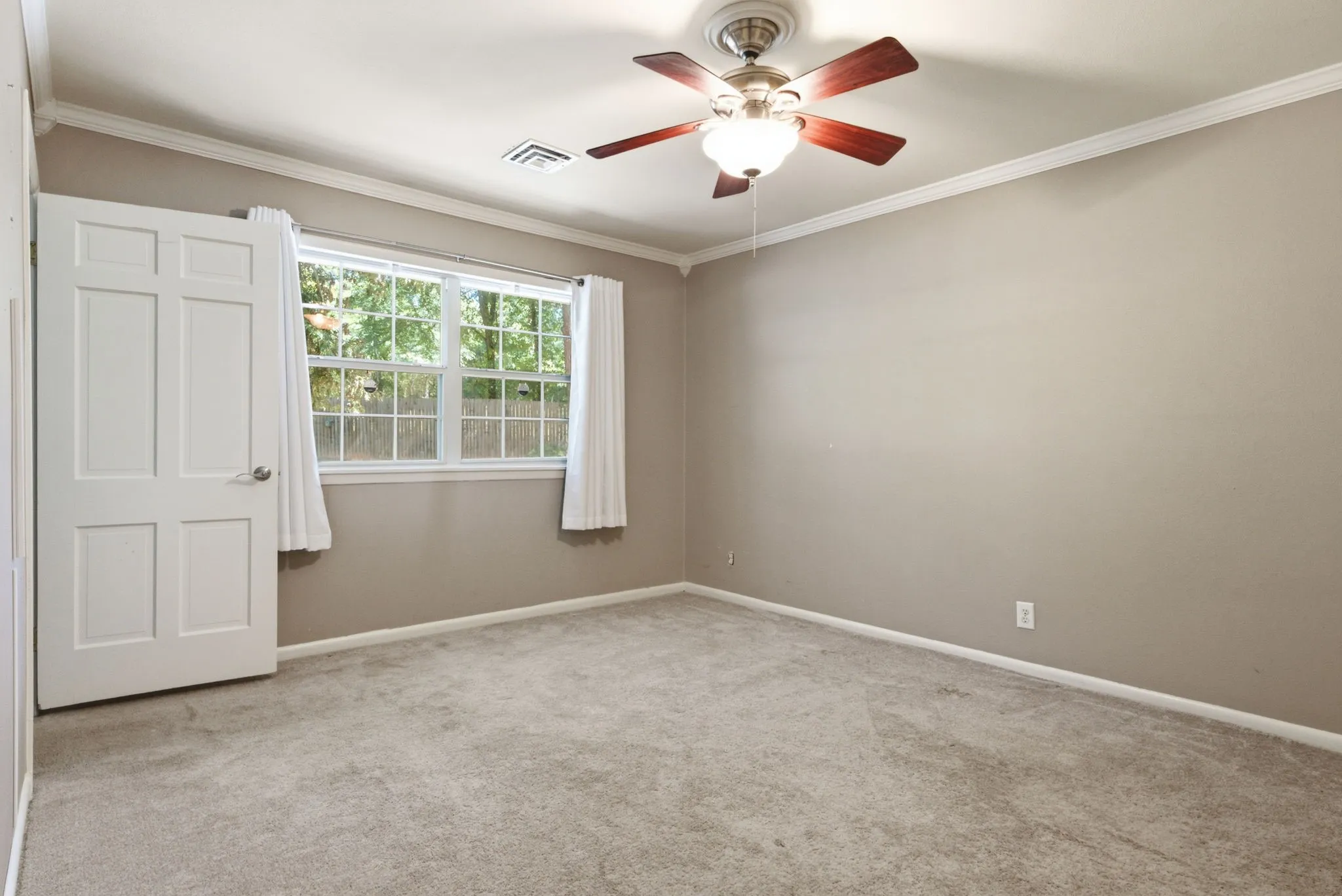 Ceiling fan with light fixture, neutral wall paint, white trim, and light-toned carpet