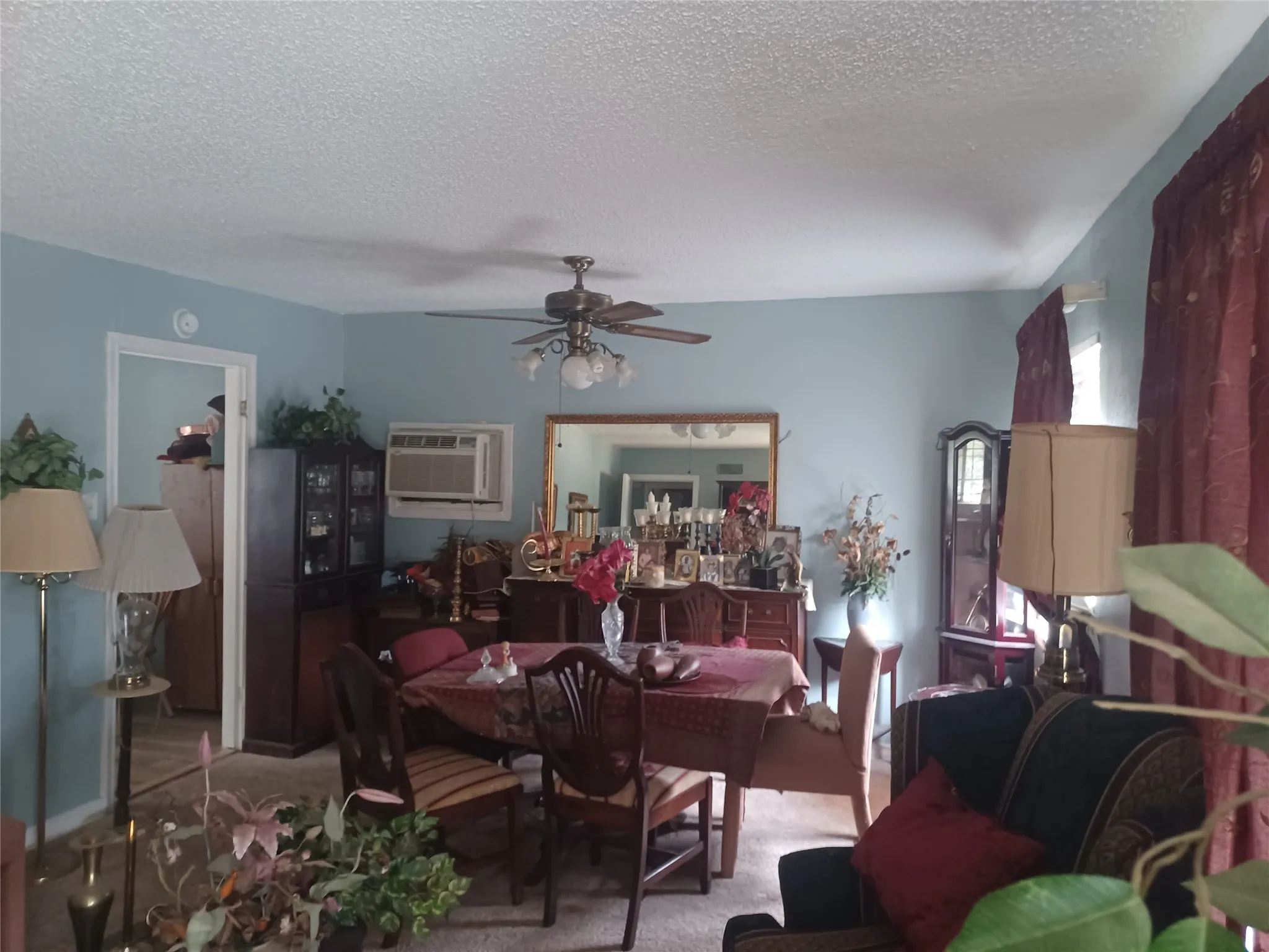 Room with light blue walls and a ceiling fan
