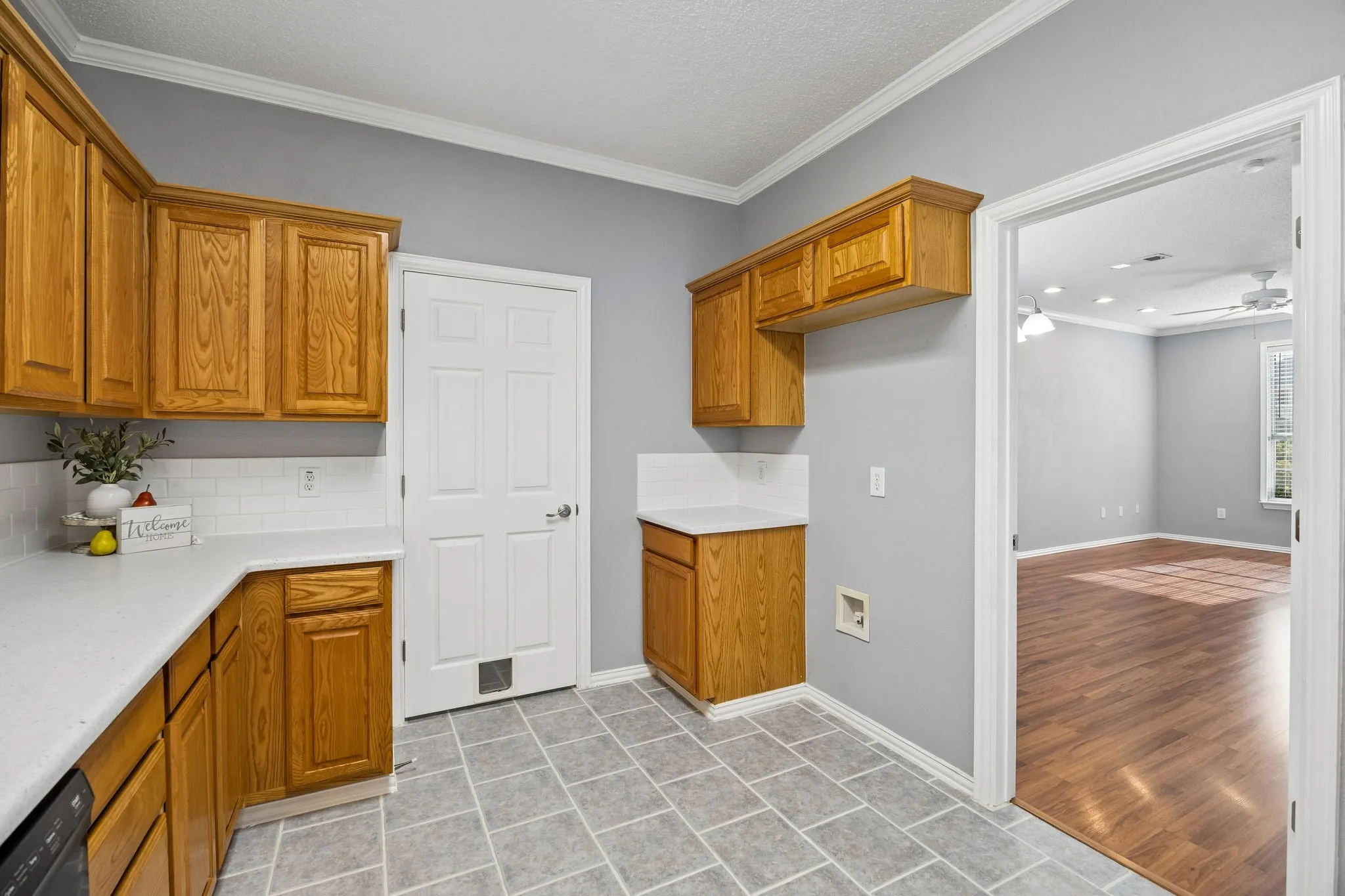 Kitchen with door to laundry room and access to dining and living room.
