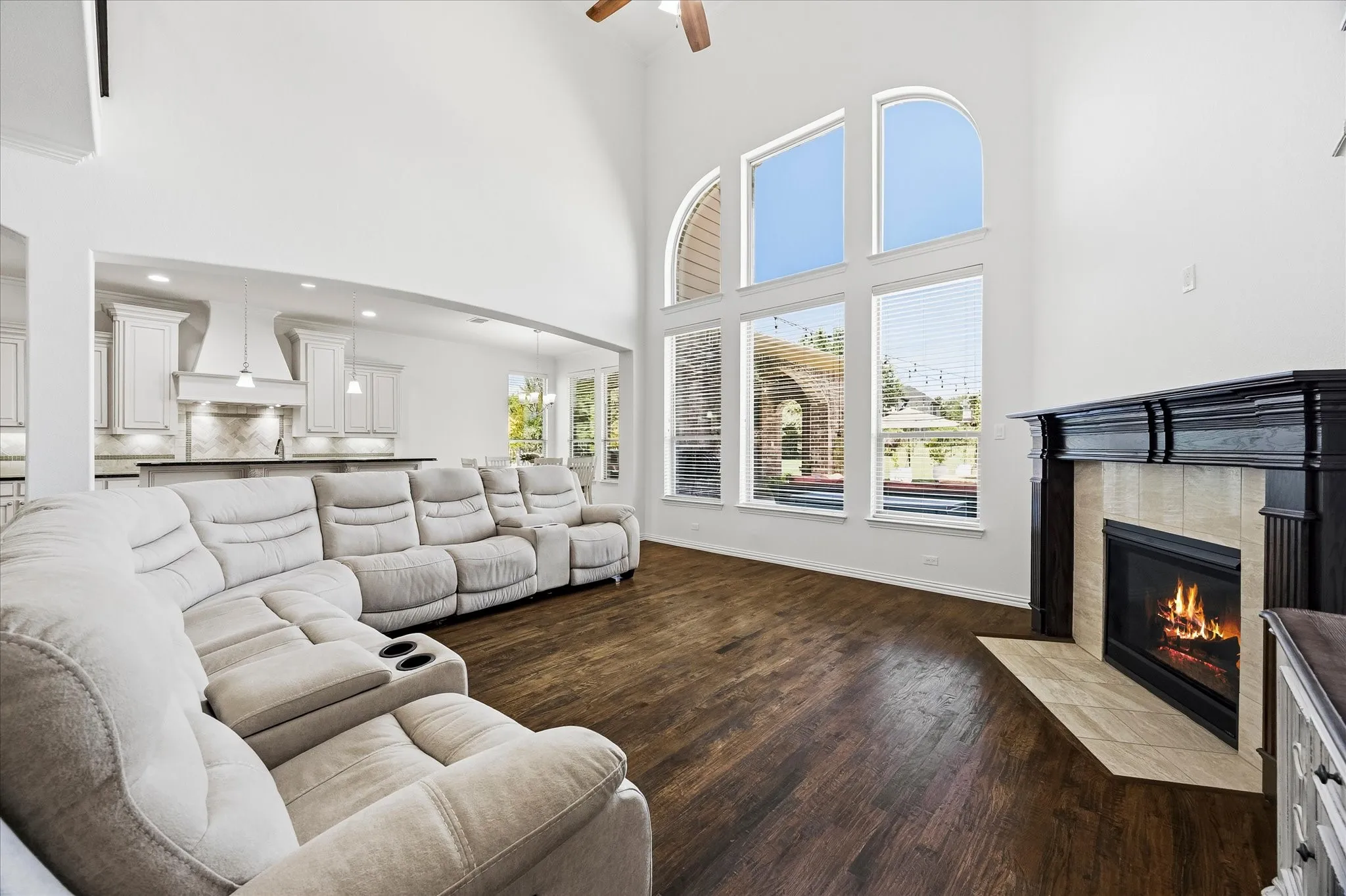 The family room is the heart of the home with a cozy gas-log fireplace and 2-story wall of windows overlooking the backyard.