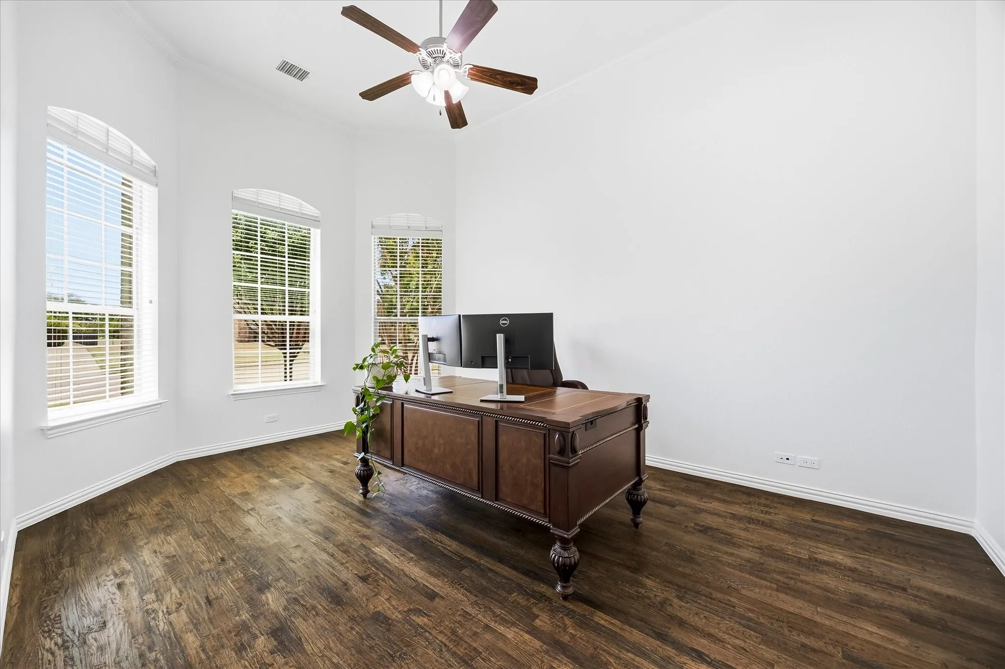 The handsome study includes French doors for privacy, crown molding and bay windows.