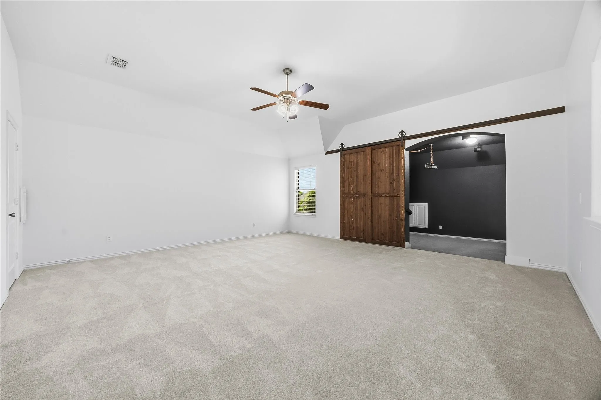 Upstairs, the enormous game room will be where everyone wants to hang out. A custom barn door separates it from the media room.