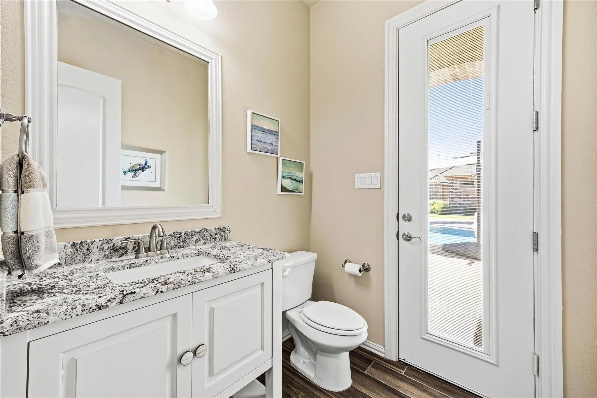 The pool bath has a door leading to the pool area and another to the hallway with a full-sized laundry closet, perfect for towels and swimsuits.