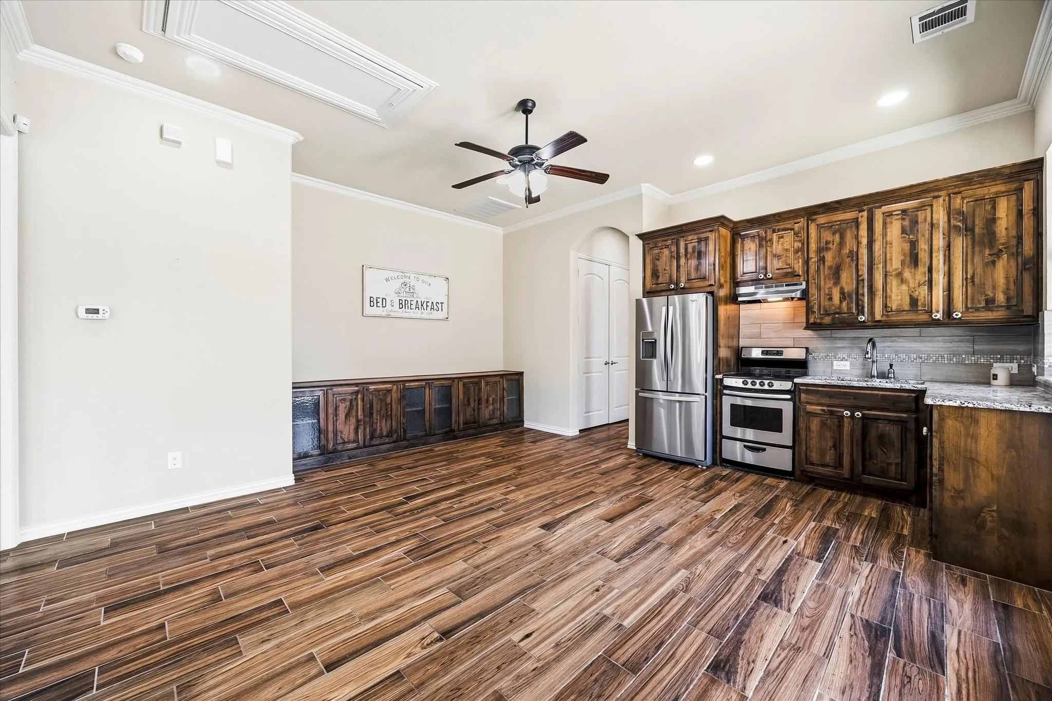 It features easy-care ceramic plank flooring throughout. The open floor plan includes a living area, built-in storage and well-equipped kitchen.