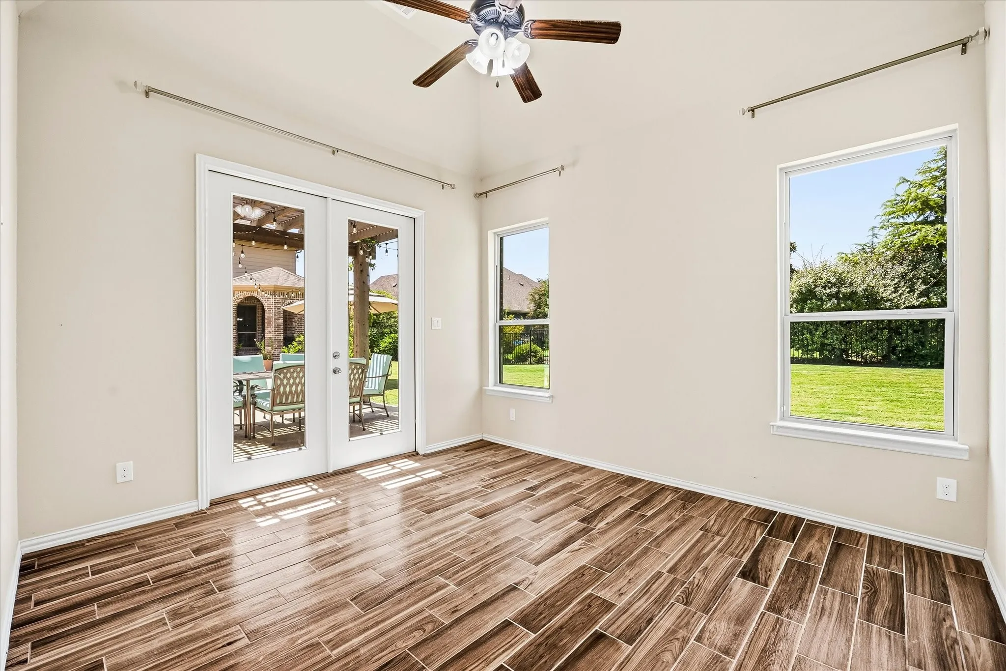 The bedroom has doors leading to the patio overlooking the pool area.