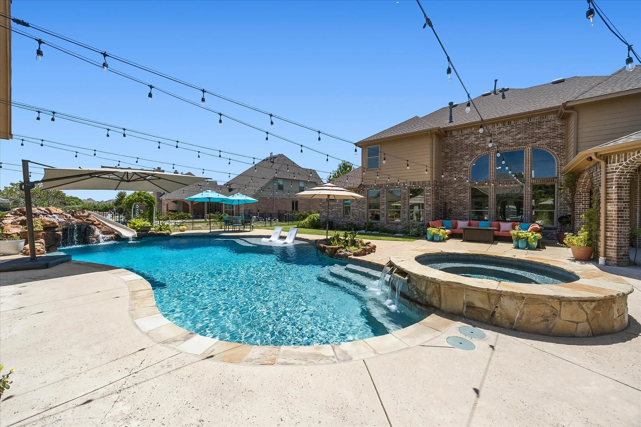 The sparkling pool boasts a 13-person hot tub with waterfalls, tanning ledge, planters and waterfall grotto with a fun slide.