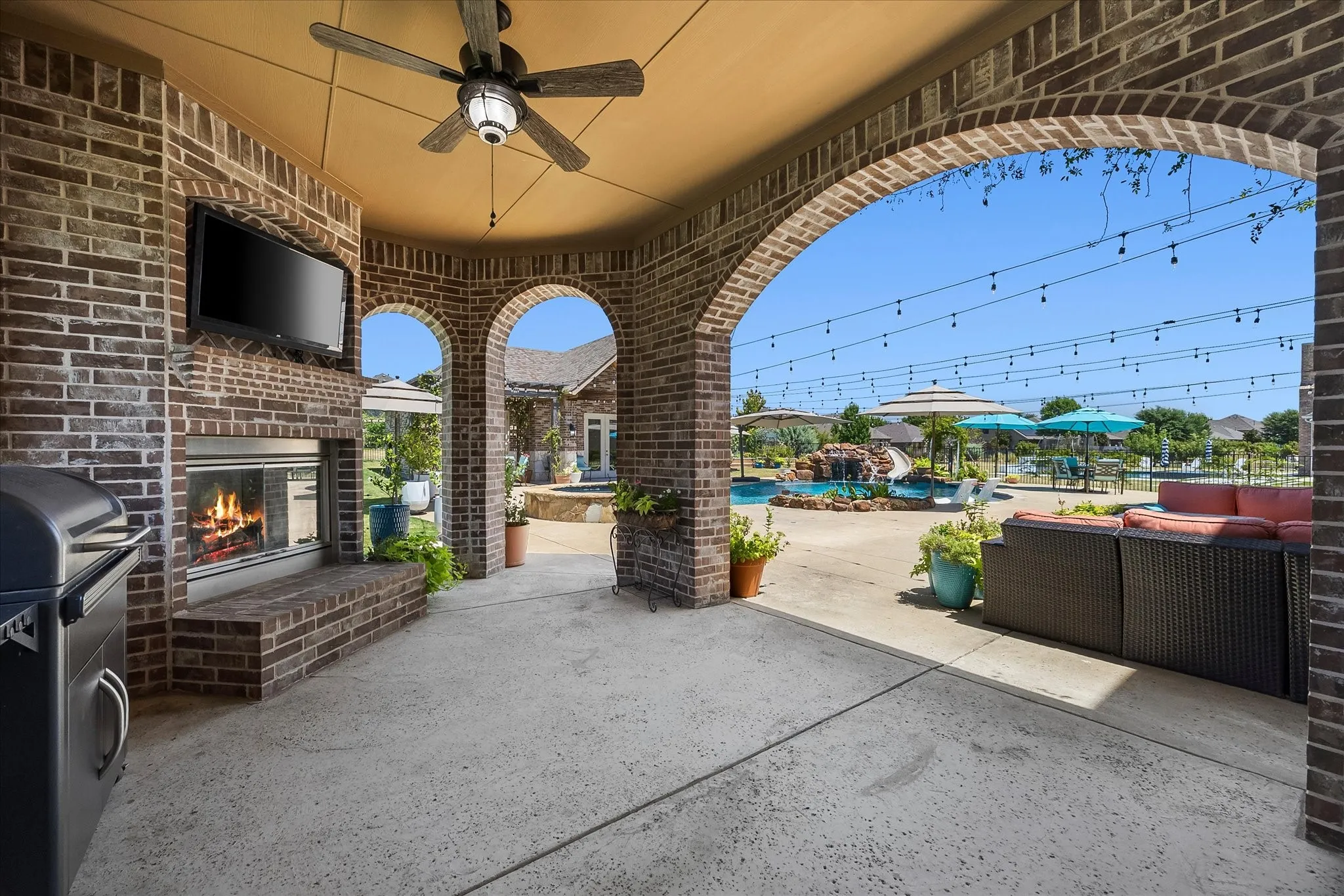 The covered patio has a gas-log fireplace, gas stub for your grill, ceiling fan and tv to catch the game.