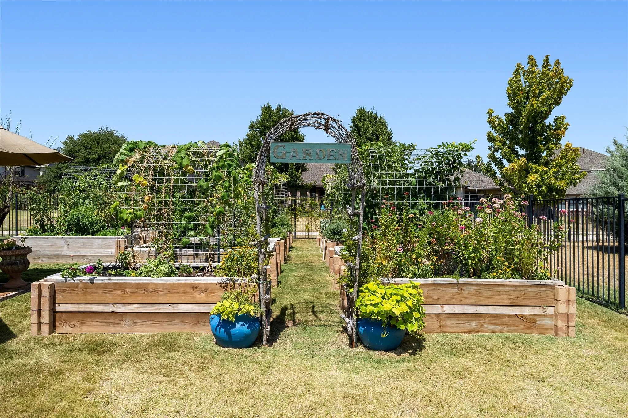 Rows of raised beds, an arbor, trellises and containers provide homegrown produce year-round.
