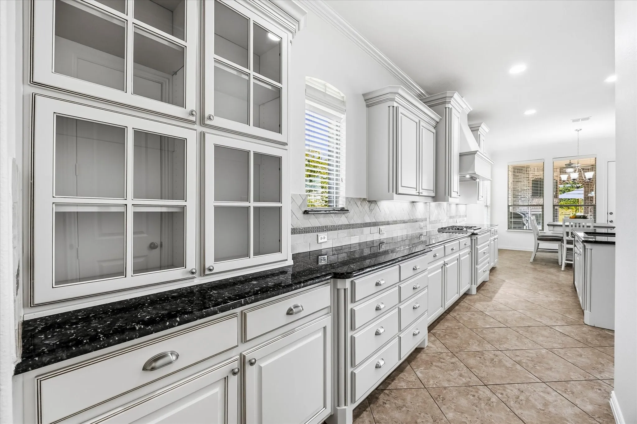 Culinary enthusiasts will delight in the abundance of granite counter tops and cabinetry, there's also a huge U-shaped walk-in pantry.