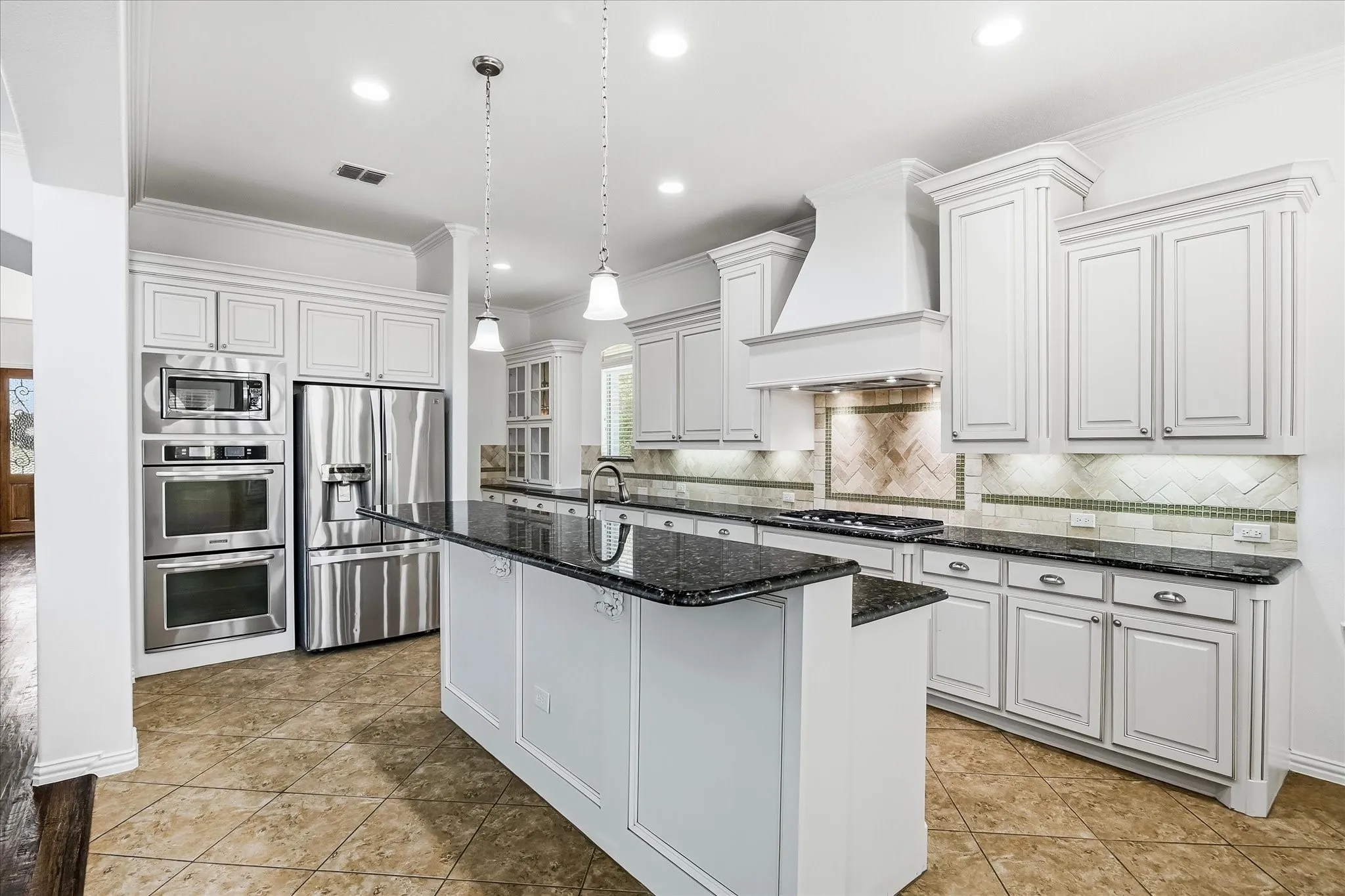 The chef's dream kitchen offers double convection ovens and 5-burner gas cooktop.
