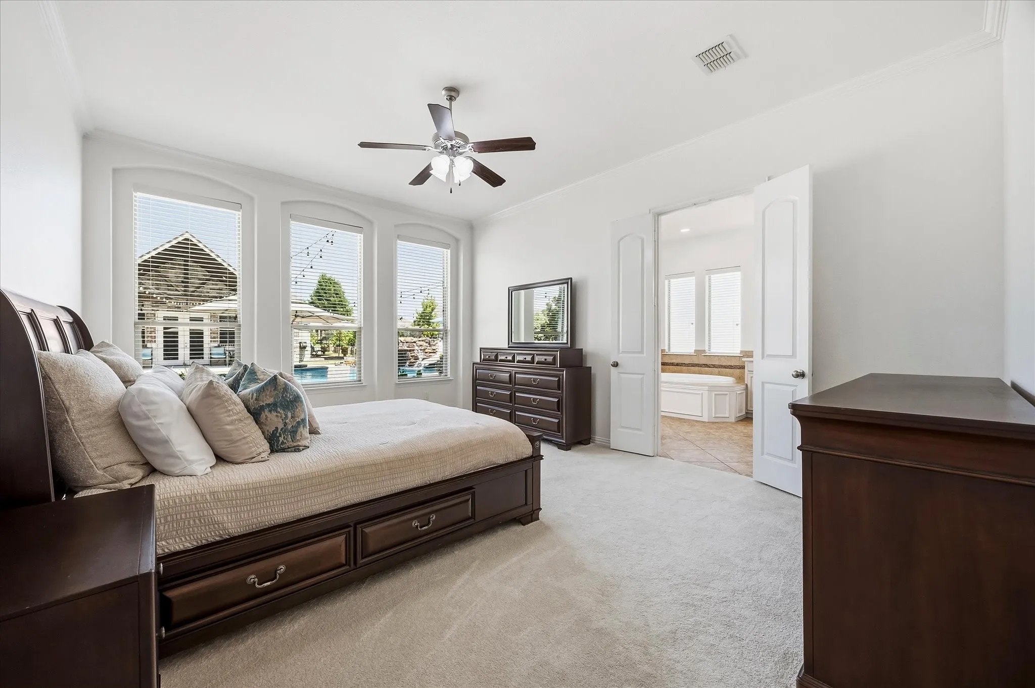 The tranquil primary retreat has a wall of windows with serene pool views. All carpeting has been recently replaced.
