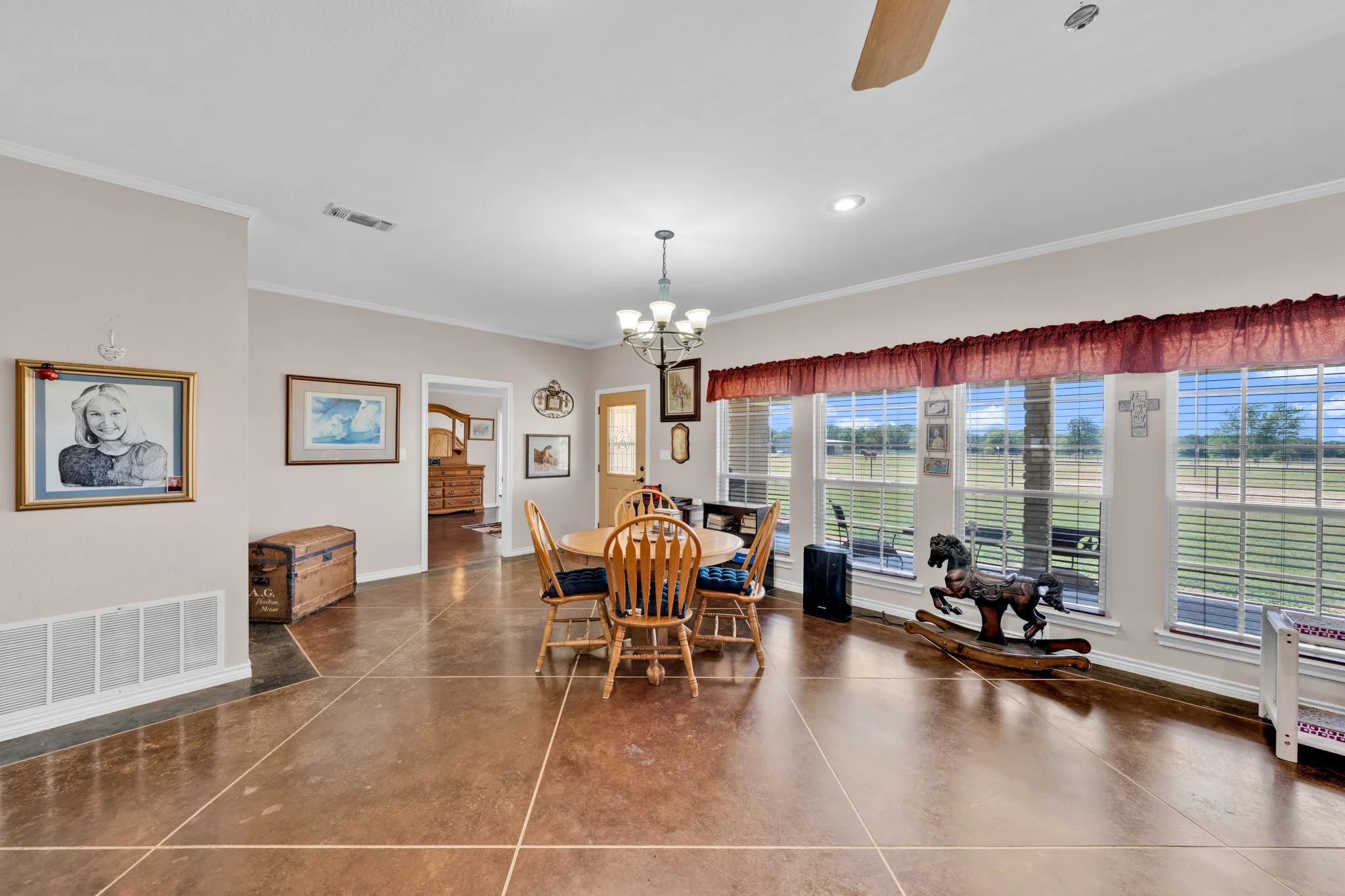 Polished concrete flooring, recessed lighting, and a ceiling fan