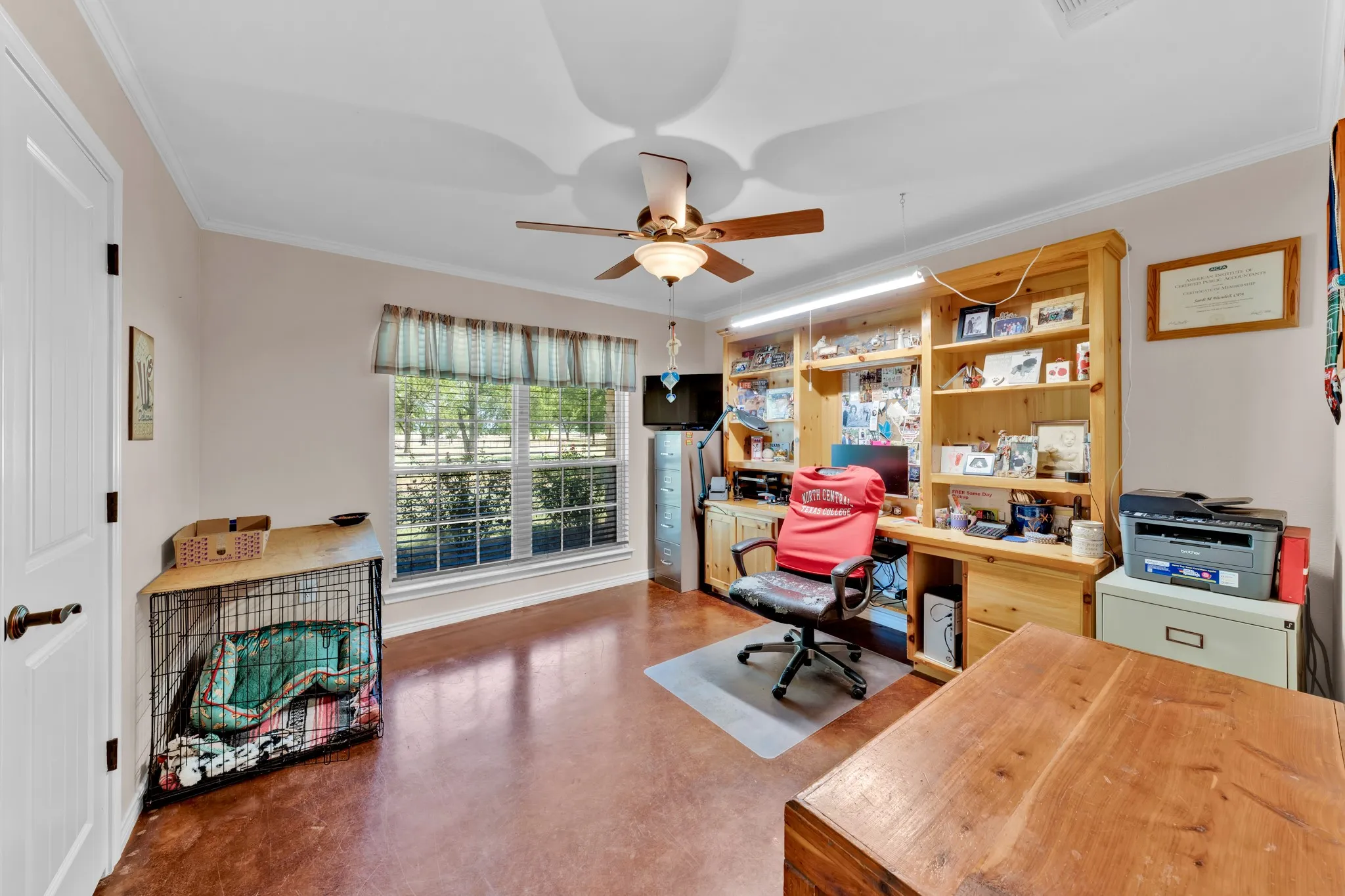 Recessed window, wood-finish flooring, ceiling fan, crown molding, built-in wooden shelving